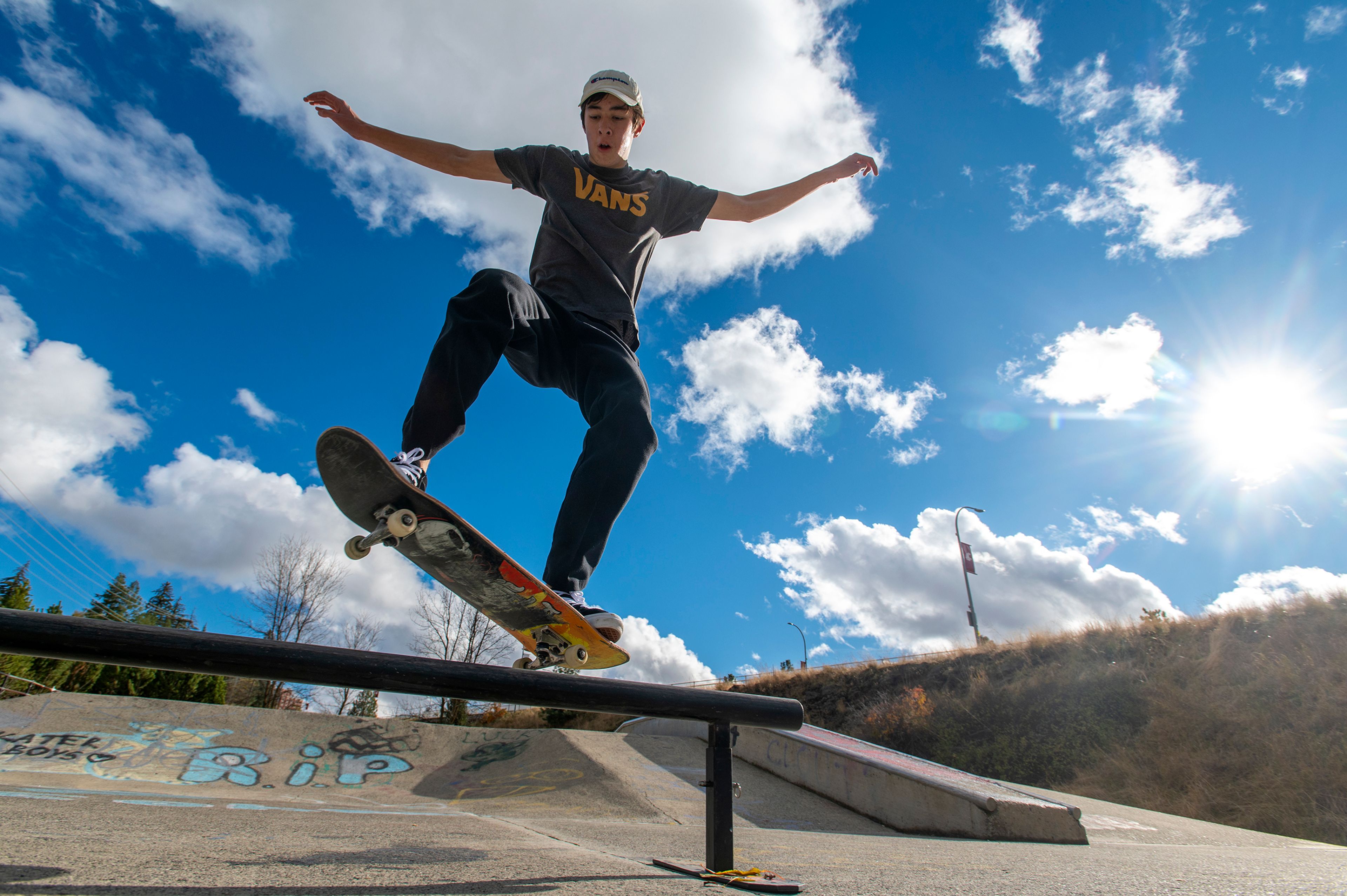 Washington State University freshman Cohen Poole performs a “crooked grind” under the sun while practicing tricks with fellow freshman Raymond Danekas, not pictured, at the Spring Street Skate Park in Pullman on Monday.