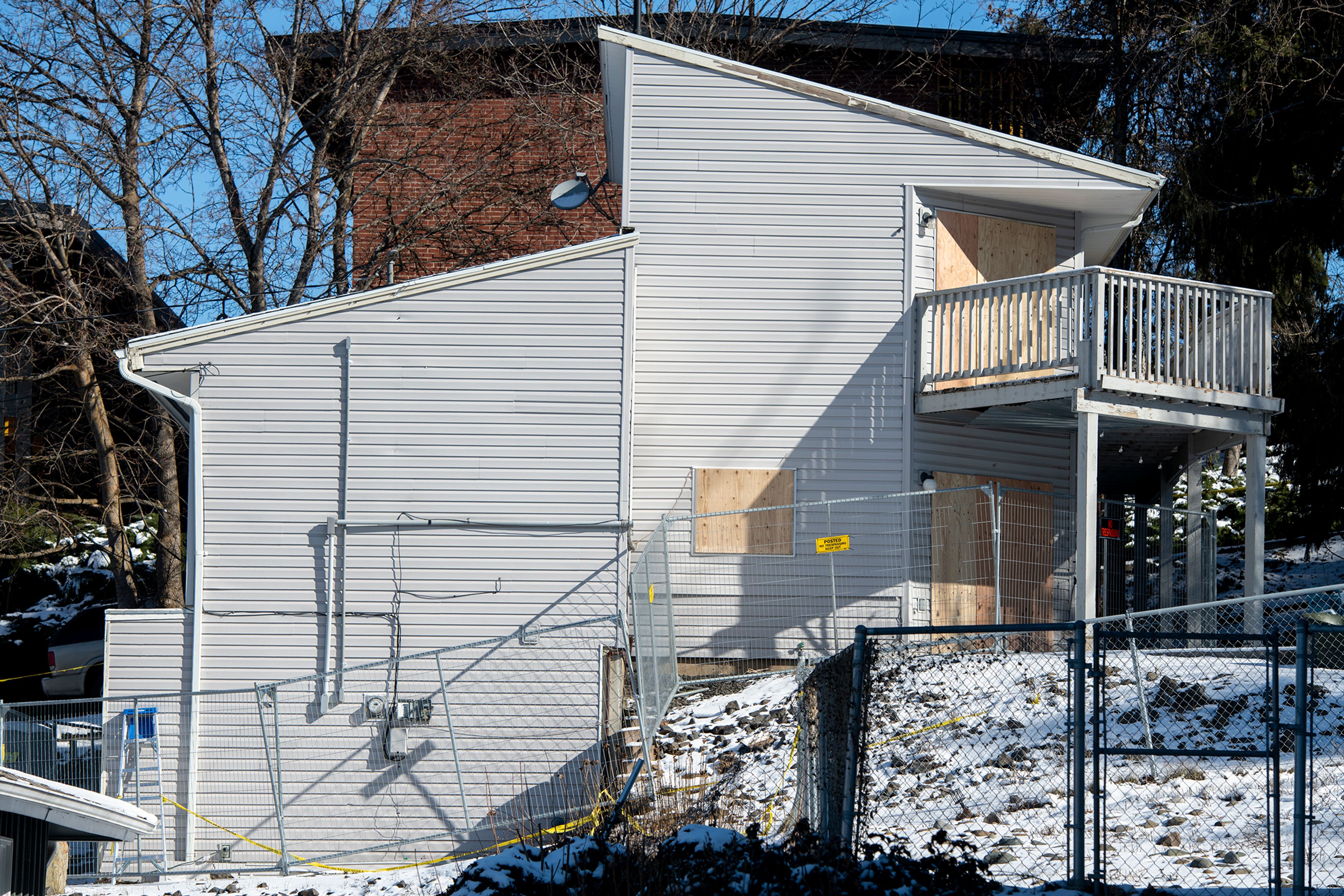 Caution tape and a fence surround the boarded up house on Moscow’s King Road where four University of Idaho students were stabbed to death in November.