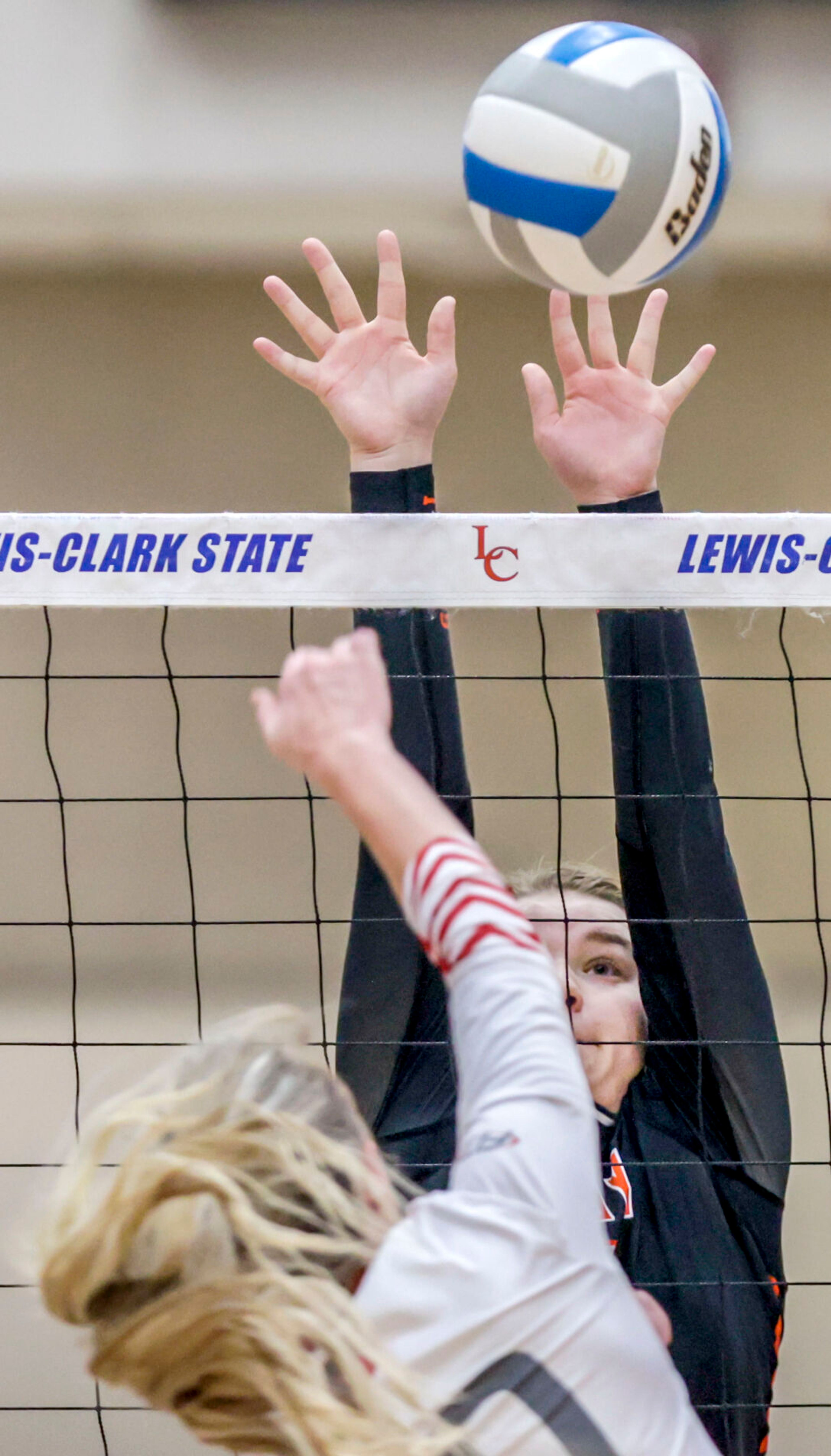 Troy middle hitter Bailee Cook leaps up to block a shot at the Lewis-Clark State College Athletic Center on Saturday. Troy defeated Grace in three sets to become the 1A DI state champions.