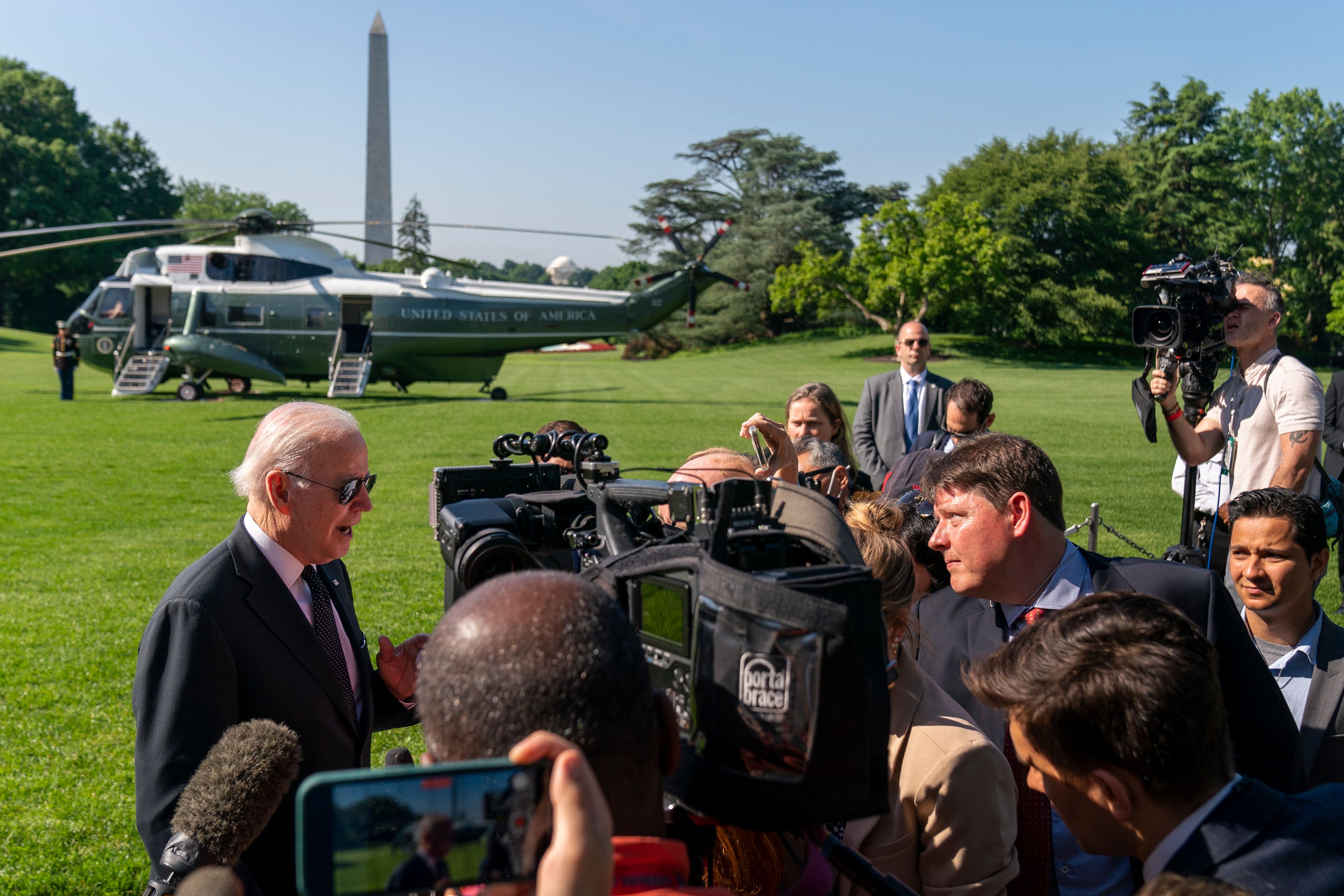 Marine One and the Washington Monument are visible as President Joe Biden speaks to members of the media on the South Lawn of the White House in Washington, Monday, May 30, 2022, after returning from Wilmington, Del. (AP Photo/Andrew Harnik)