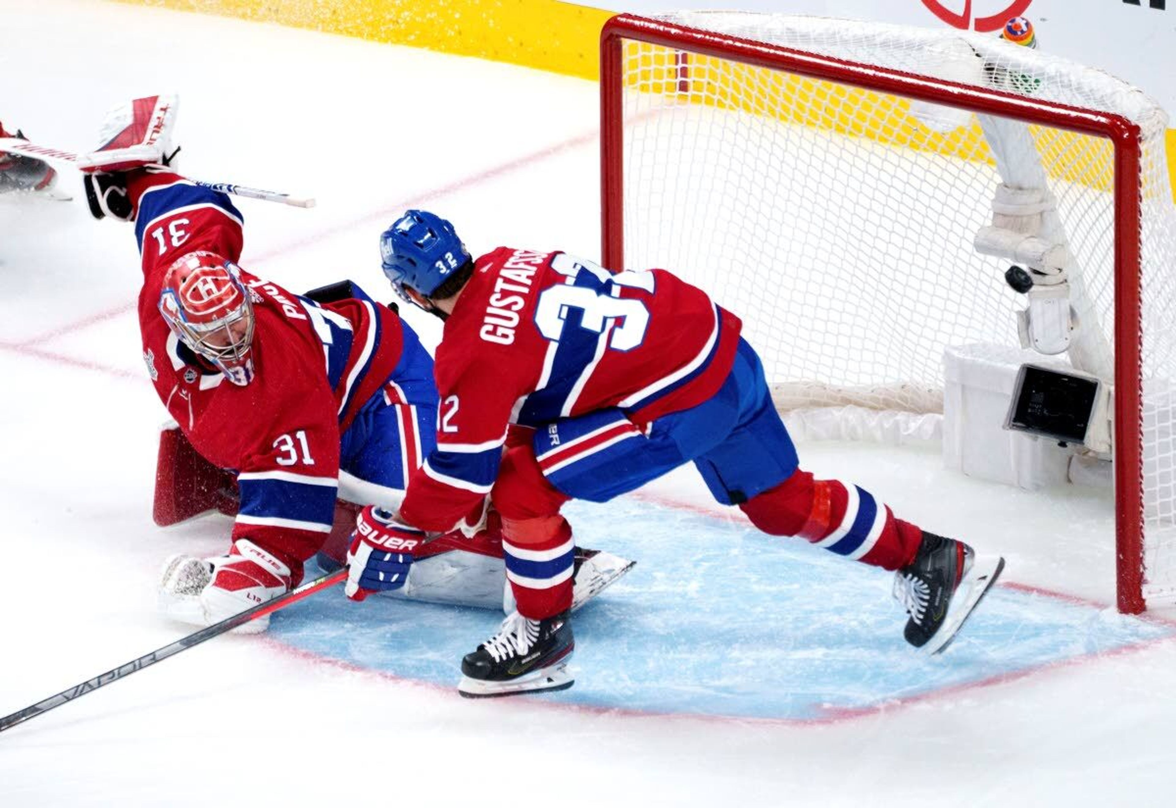 The puck sails into the net past Montreal Canadiens goaltender Carey Price on a goal by Tampa Bay Lightning's Tyler Johnson, as defenseman Erik Gustafsson looks on during the second period of Game 3 of the NHL hockey Stanley Cup Final, Friday, July 2, 2021, in Montreal. (Paul Chiasson/The Canadian Press via AP)