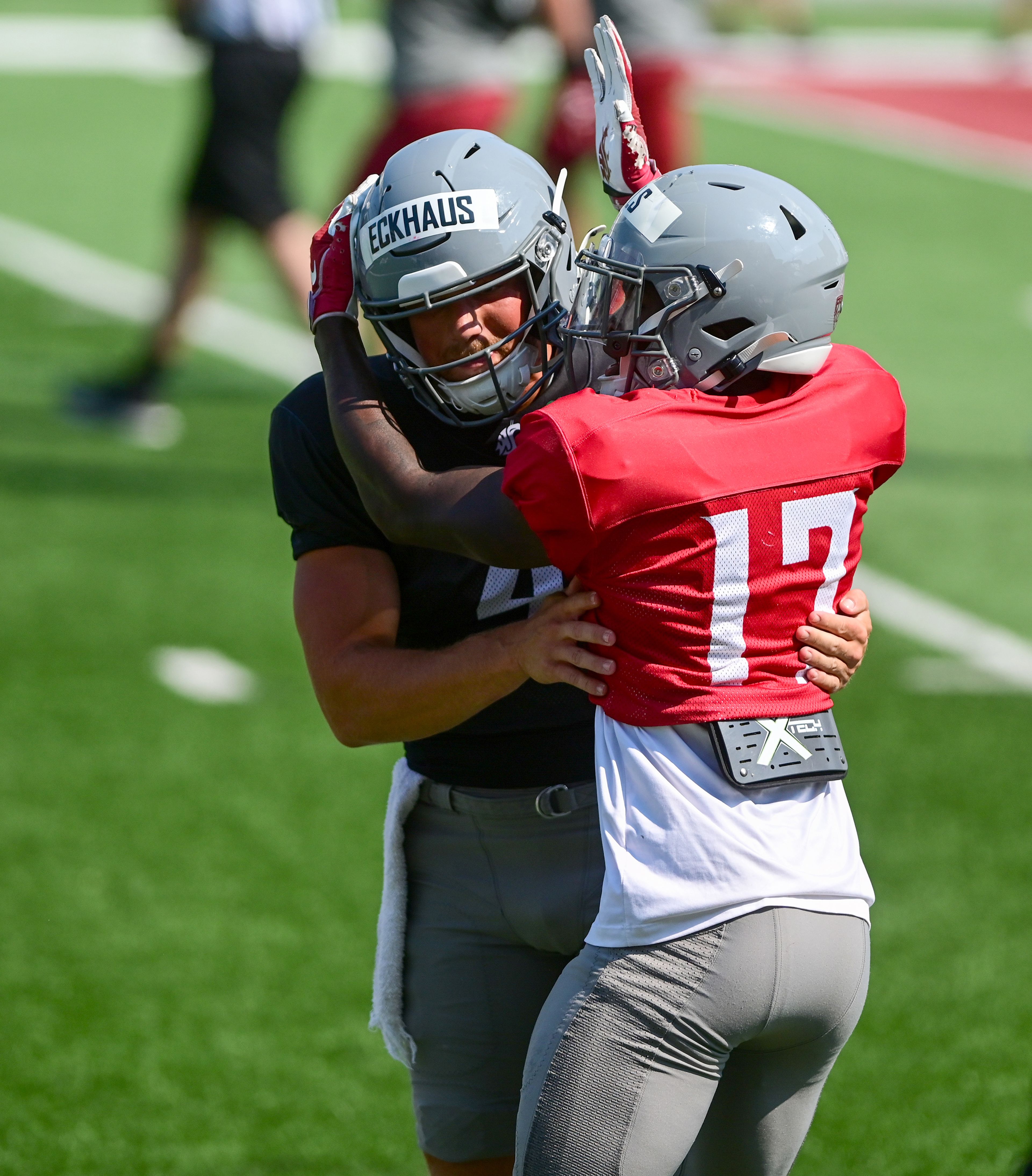 Washington State quarterback Zevi Eckhaus and wide receiver Brandon Hills embrace after a touchdown at a fall practice scrimmage on Saturday in Pullman.