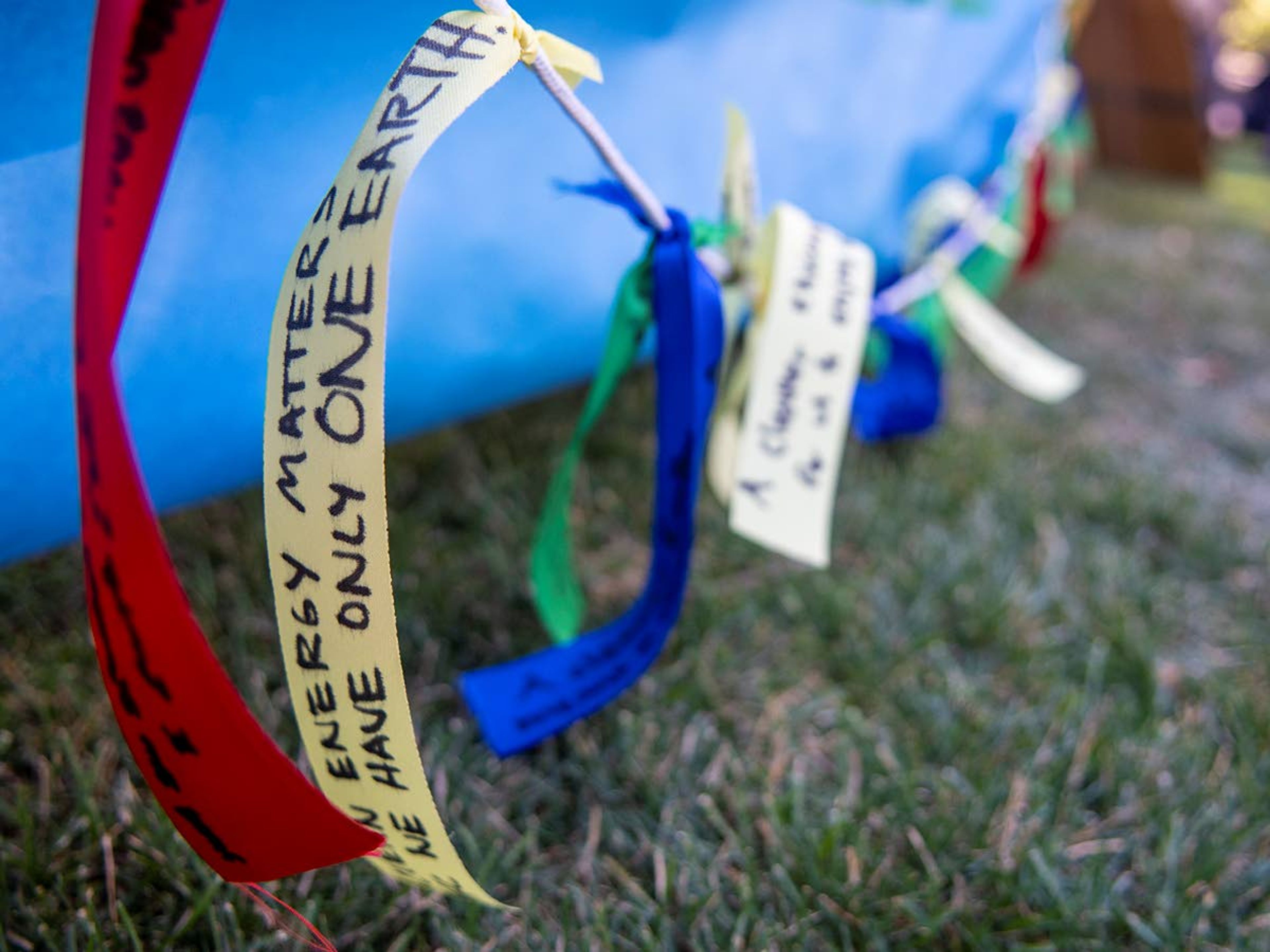 Hand-written ribbons are strung across a table during the Fridays for Future strike at East City Park in Moscow on Friday morning. The ribbon seen in this image reads, “Clean energy matters. We only have one Earth!”