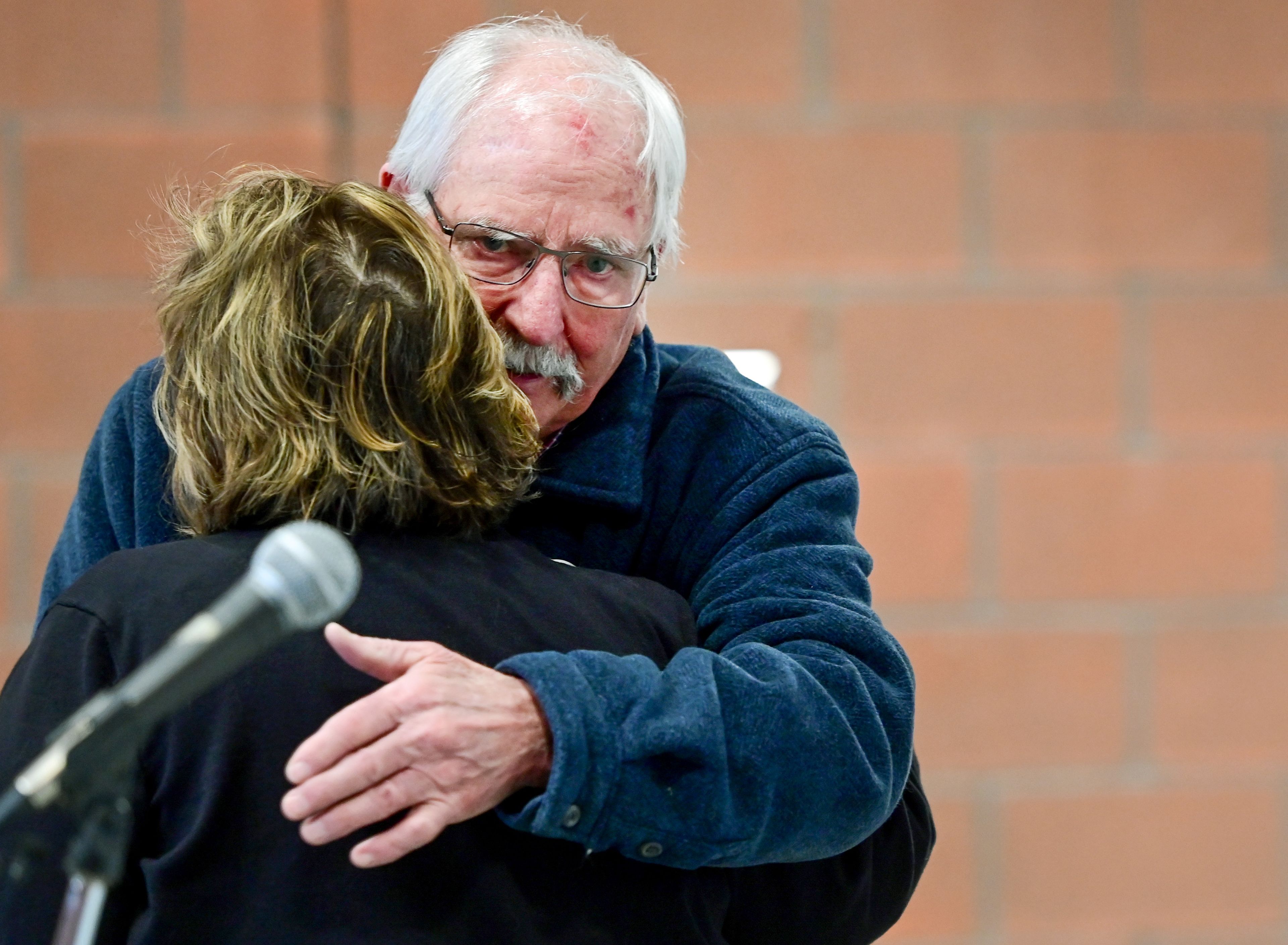 Malden city clerk Micki Harnois and Mayor Dan Harwood, right, embrace at a ribbon cutting at the city’s new facilities on Thursday.