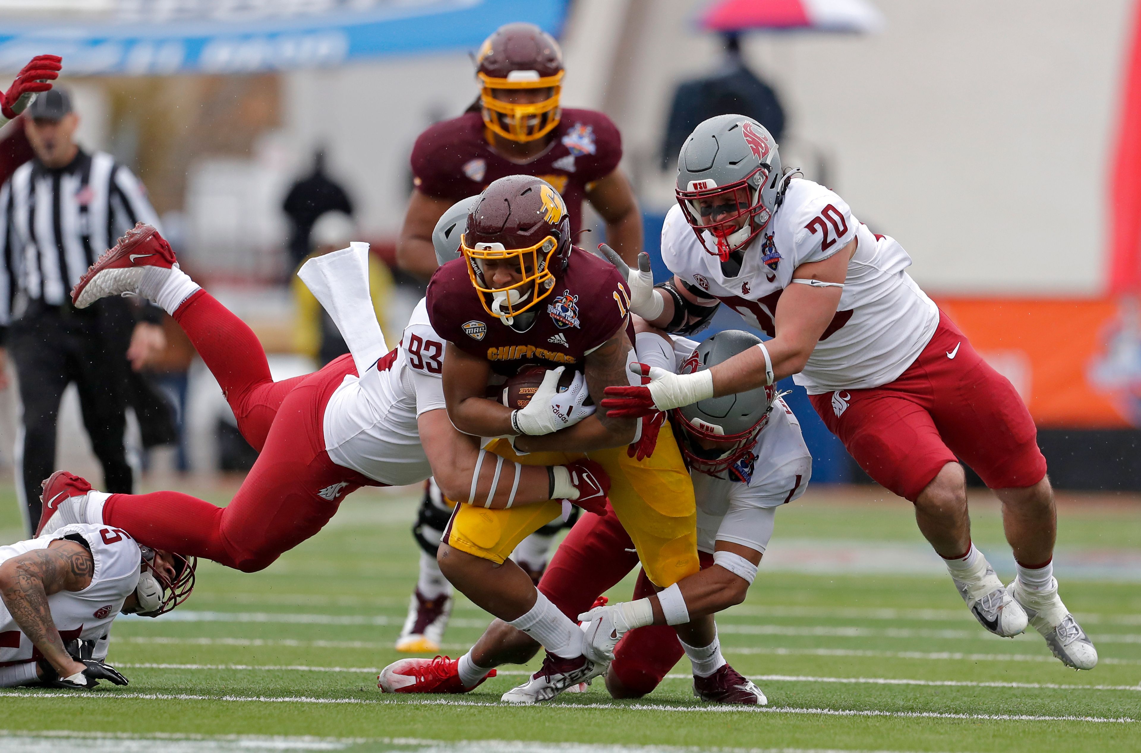 Associated PressWashington State defensive lineman Christian Mejia (93), edge rusher Quinn Roff (20) and defensive back Tyrone Hill Jr. tackle Central Michigan wide receiver JaCorey Sullivan (11) Dec. 31, 2021, during the Sun Bowl in El Paso, Texas.