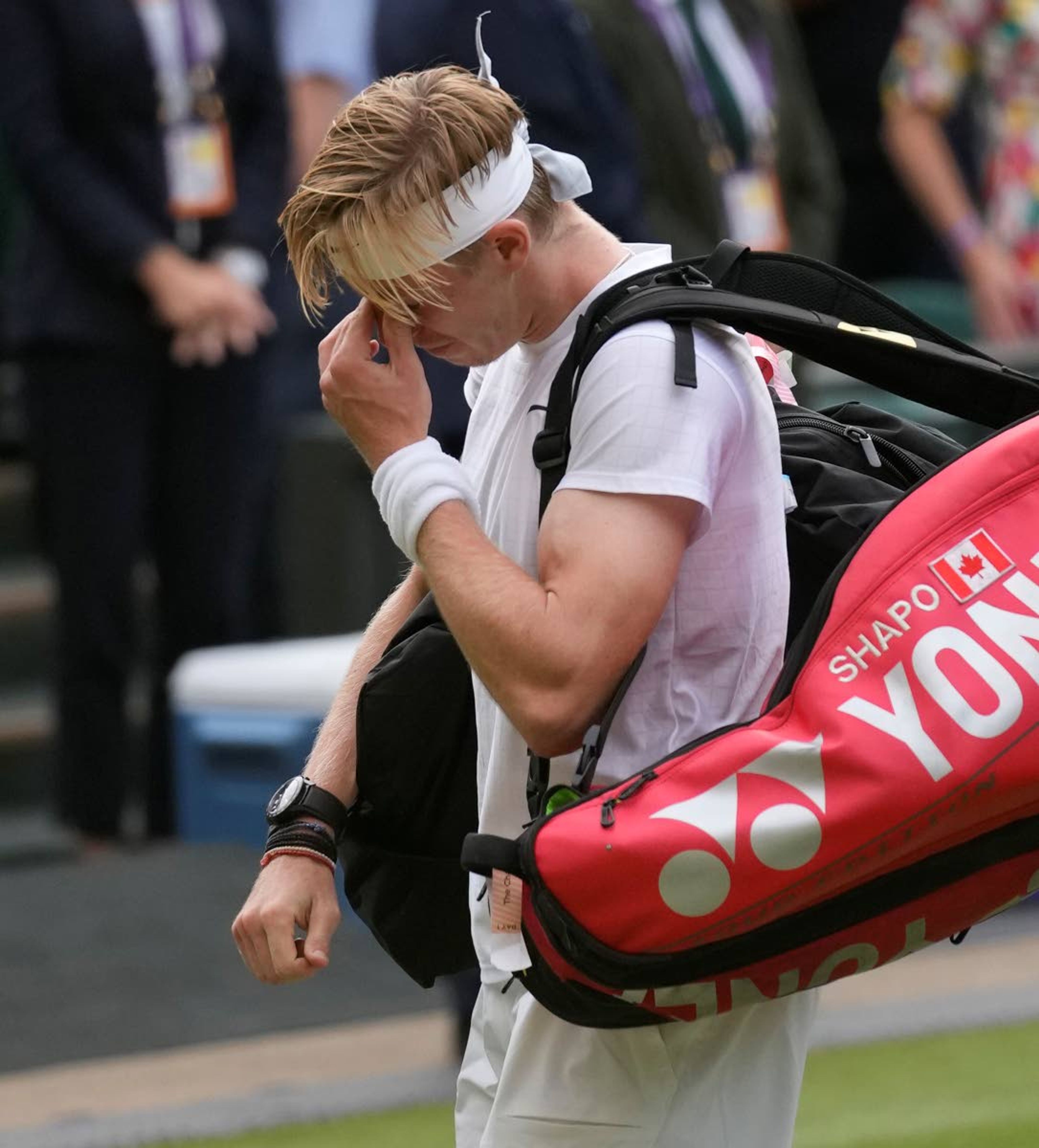 Canada's Denis Shapovalov leaves the court after being defeated by Serbia's Novak Djokovic during the men's singles semifinals match on day eleven of the Wimbledon Tennis Championships in London, Friday, July 9, 2021. (AP Photo/Kirsty Wigglesworth)