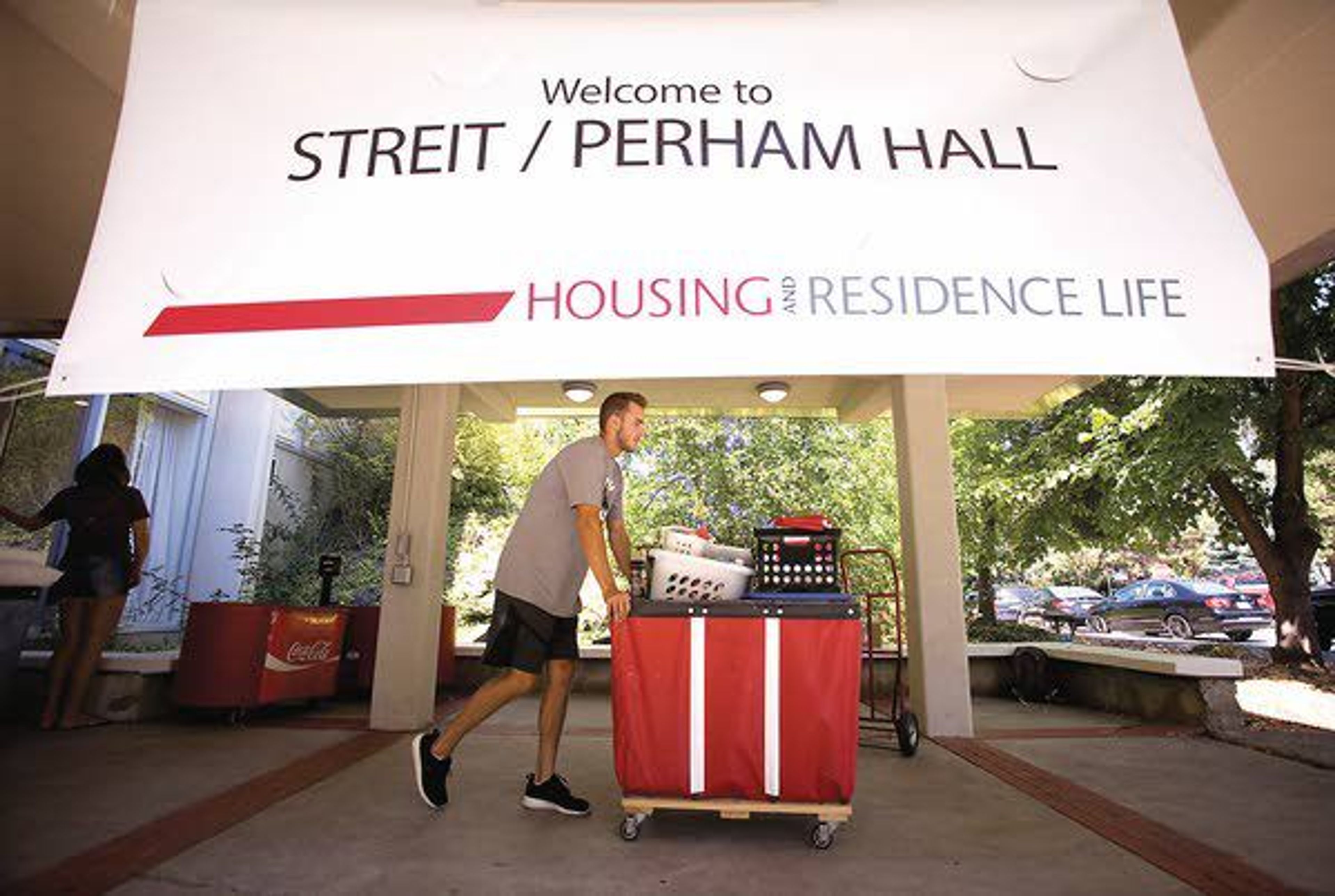 A Washington State University student pushes a cart outside Streit-Perham Hall on the first day to move into residence halls Wednesday in Pullman.