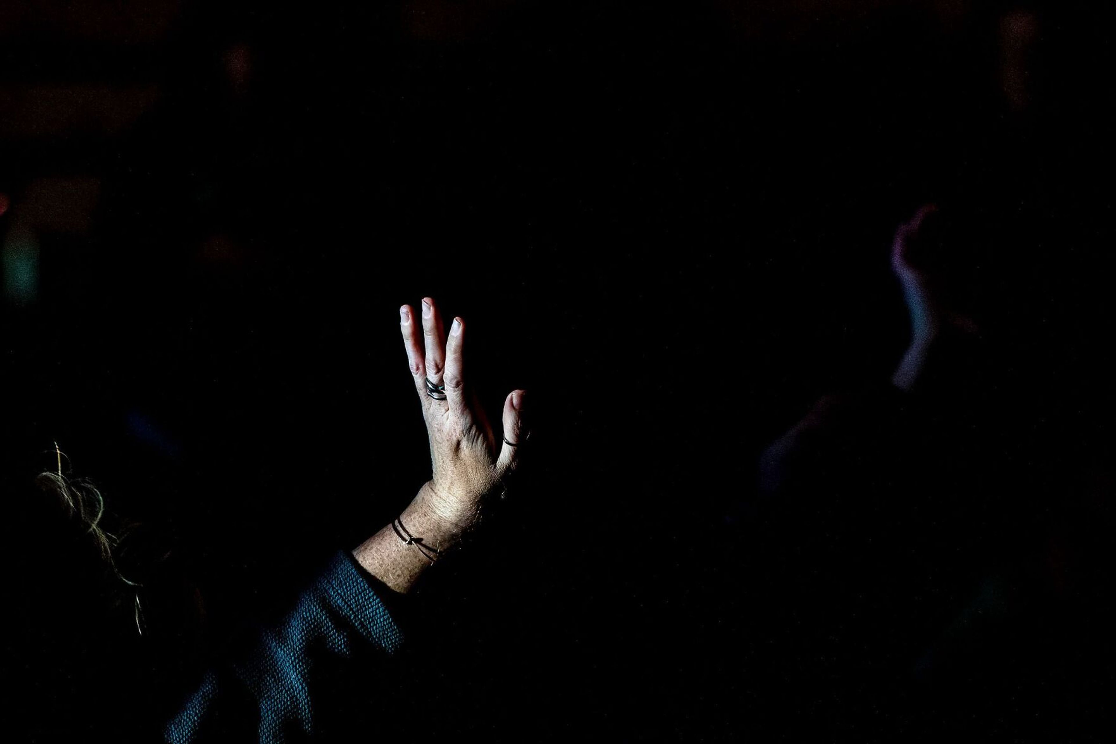 A reporter raises their hand to ask a question at a press conference on the quadruple homicide investigation in Moscow at the ICCU Arena on Sunday.