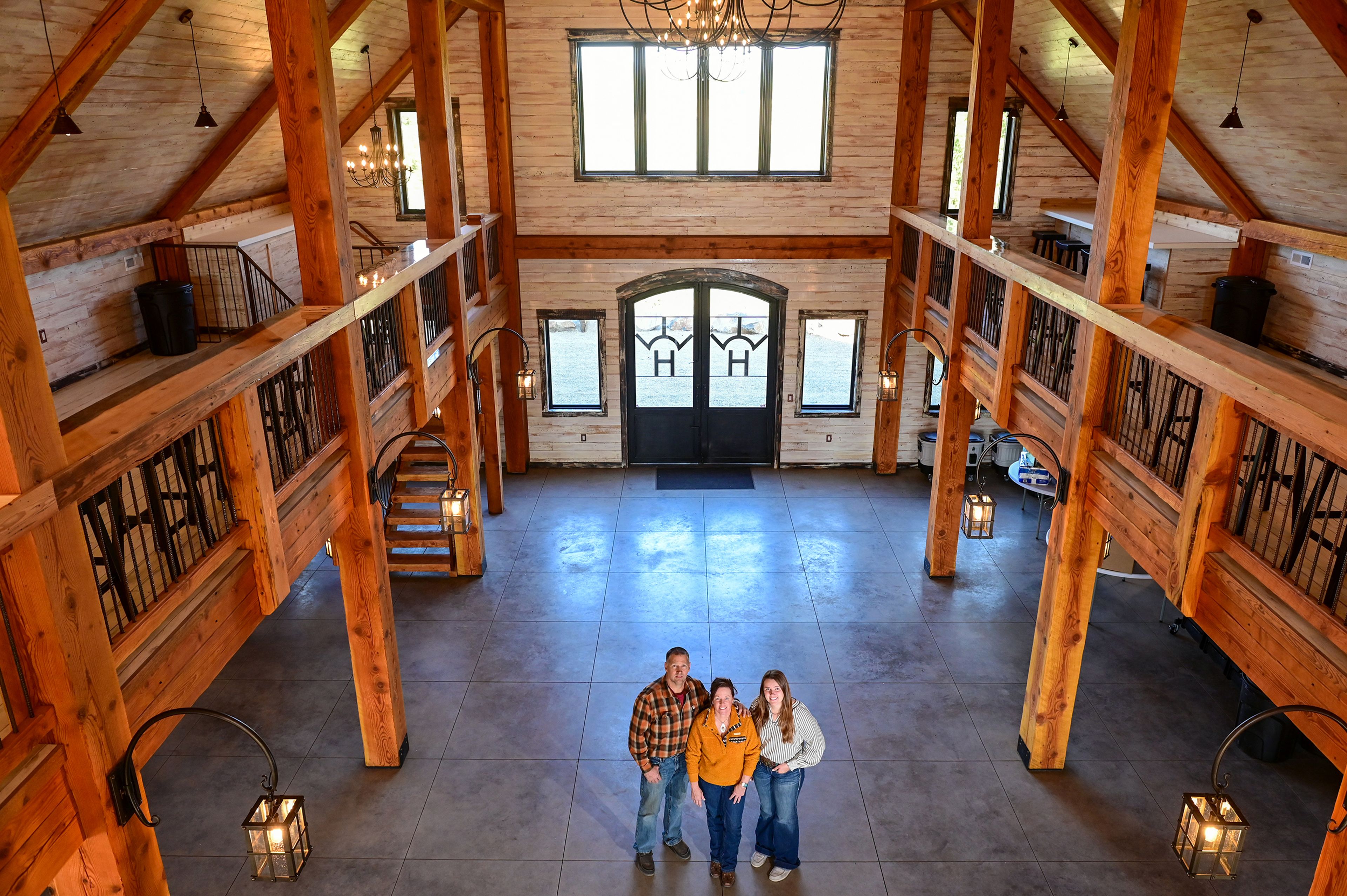 Ryan Fredrickson, left, and his wife, Teri Fredrickson, center, and their daughter, Savannah Fredrickson, stand in the Edge of Heaven Wedding and Event Barn in Deary.