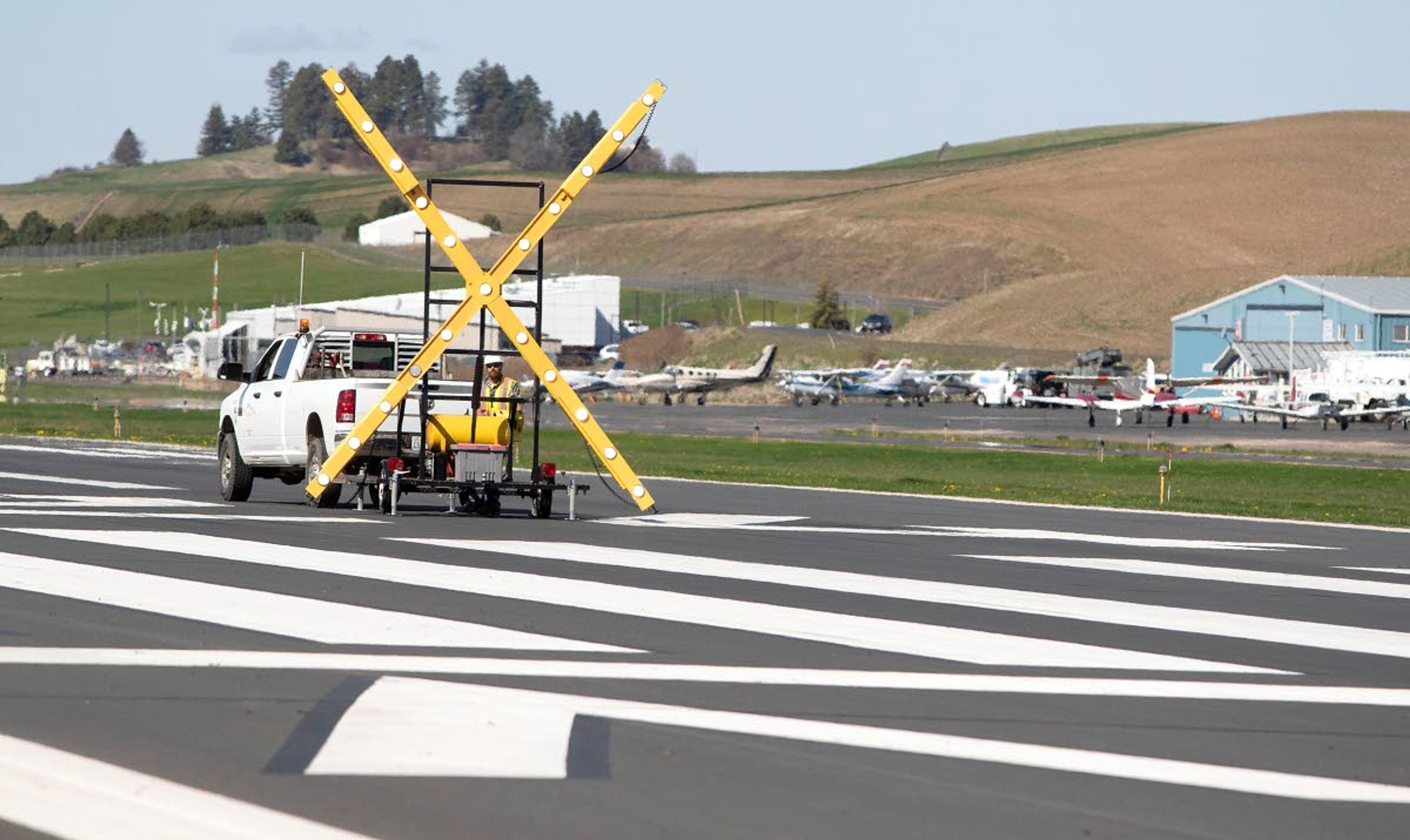 Geoff Crimmins/Daily NewsA truck prepares to move a giant X showing the runway was closed at the Pullman-Moscow Regional Airport. The runway closed for a few hours while a paving crew was working on the new runway that will open Oct. 4.