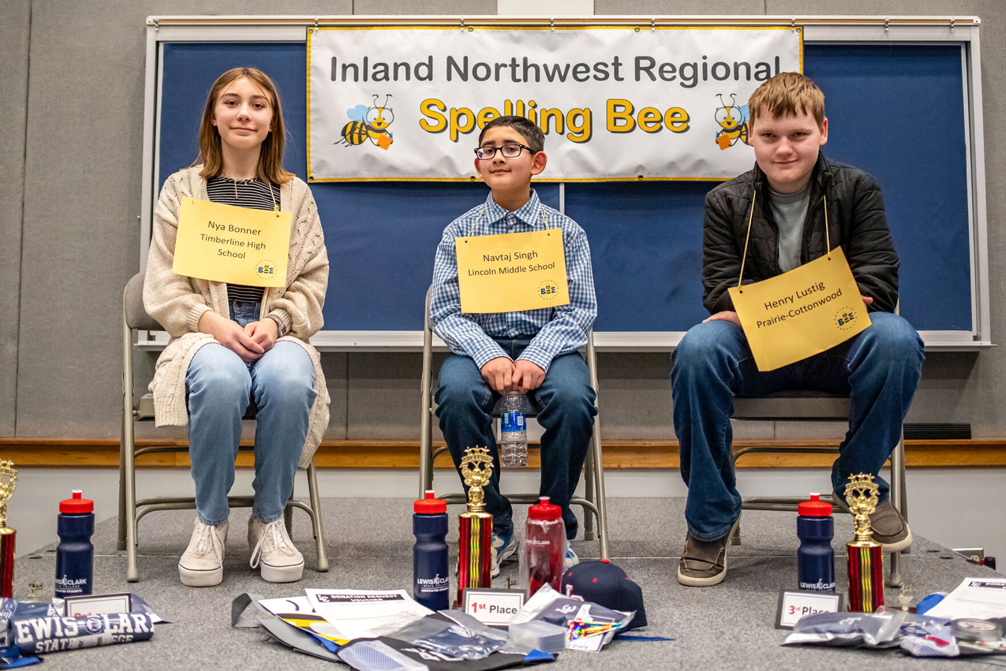 Finalist Nya Bonner, left to right, Navtaj Singh and Henry Lustig, pose on the podium Saturday after finishing the Inland Northwest Regional Spelling Bee at Lewis-Clark State College in Lewiston.