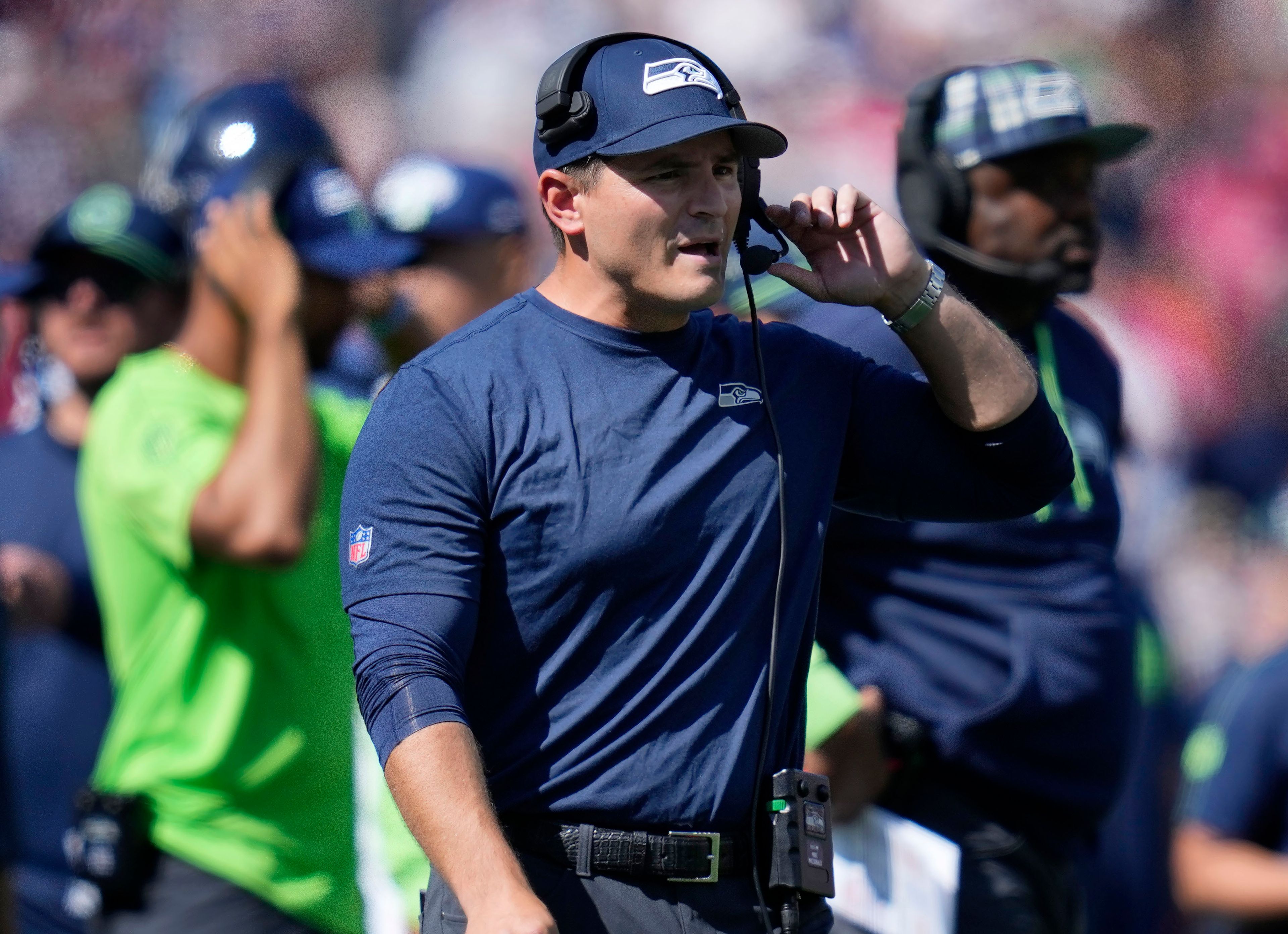 Seattle Seahawks head coach Mike Macdonald speaks into his headset in the first half of an NFL football game against the New England Patriots, Sunday, Sept. 15, 2024, in Foxborough, Mass. (AP Photo/Charles Krupa)