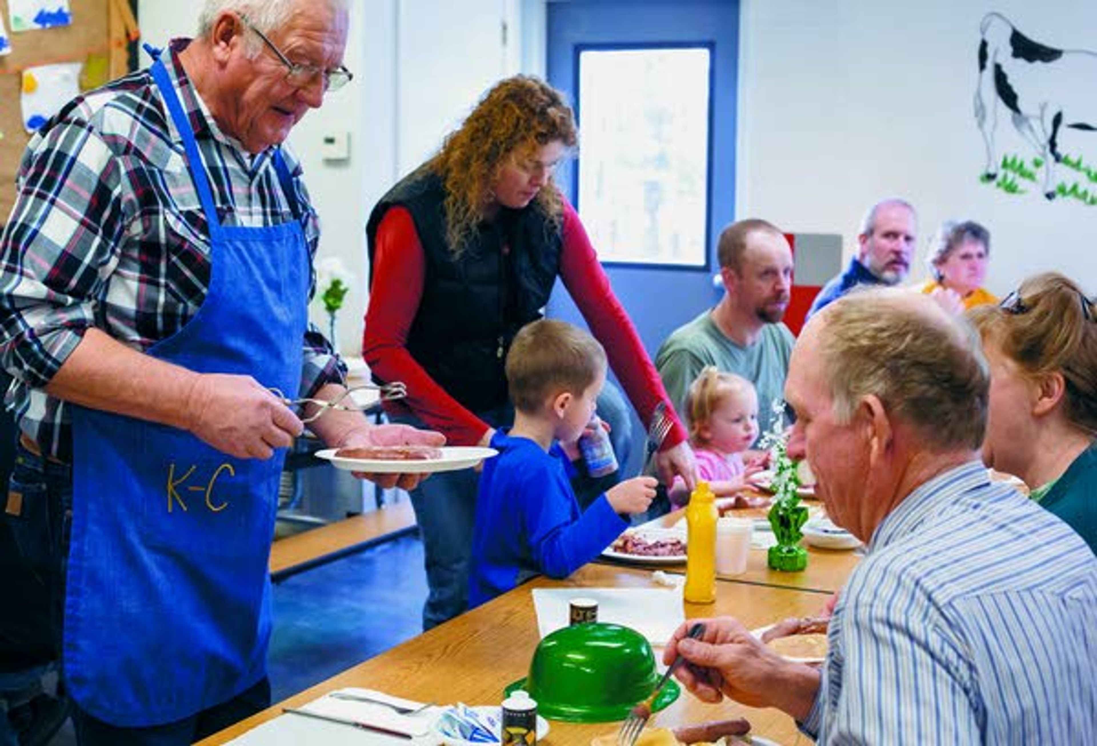 Kenny King, left, checks to see if anyone wants more sausage during the Potlatch Knights of Columbus Pancake and Sausage Feed on Sunday, March 16, 2014, at Potlatch Elementary School.