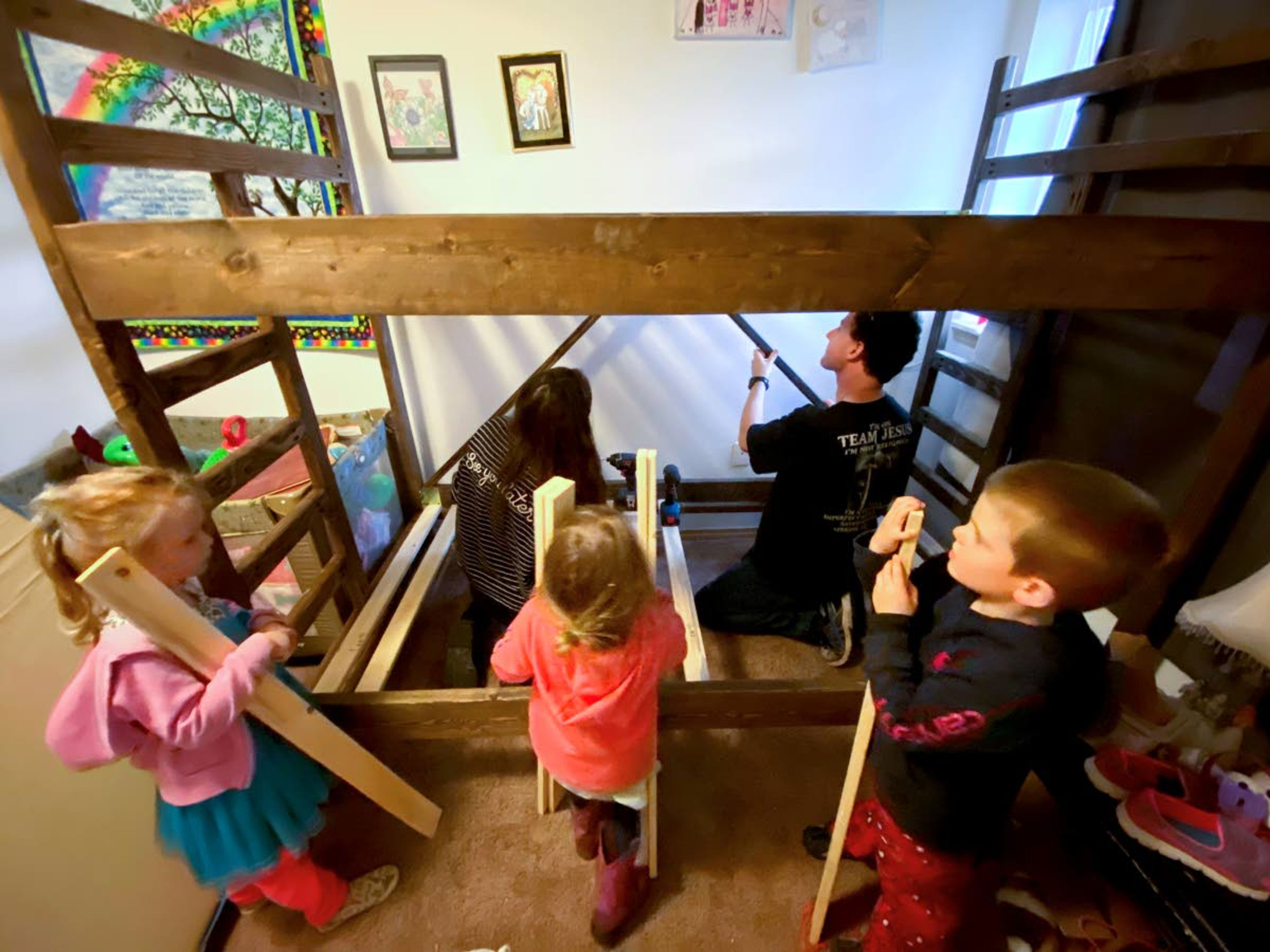 Courtesy Blessing BedsBlessing Beds volunteer Derek Boyle, back right, leads the way as children help with the construction of a bunkbed Jan. 2, 2021.