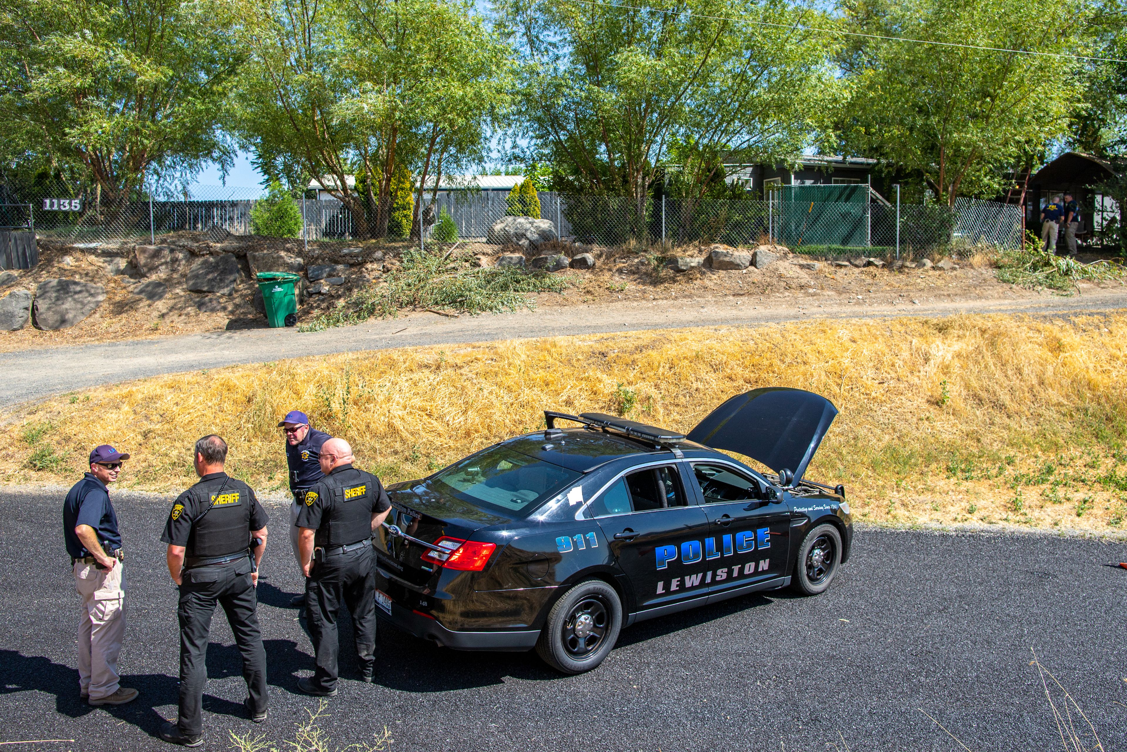 Local law enforcement and FBI agents investigate the scene of a suspected homicide Tuesday at a home on Harvest Road in North Lewiston. Mother and daughter Kay and Kimberly Morrison were arrested Tuesday and charged with first-degree murder in the death of Kenneth Morrison, who was their ex-husband and father, respectively.