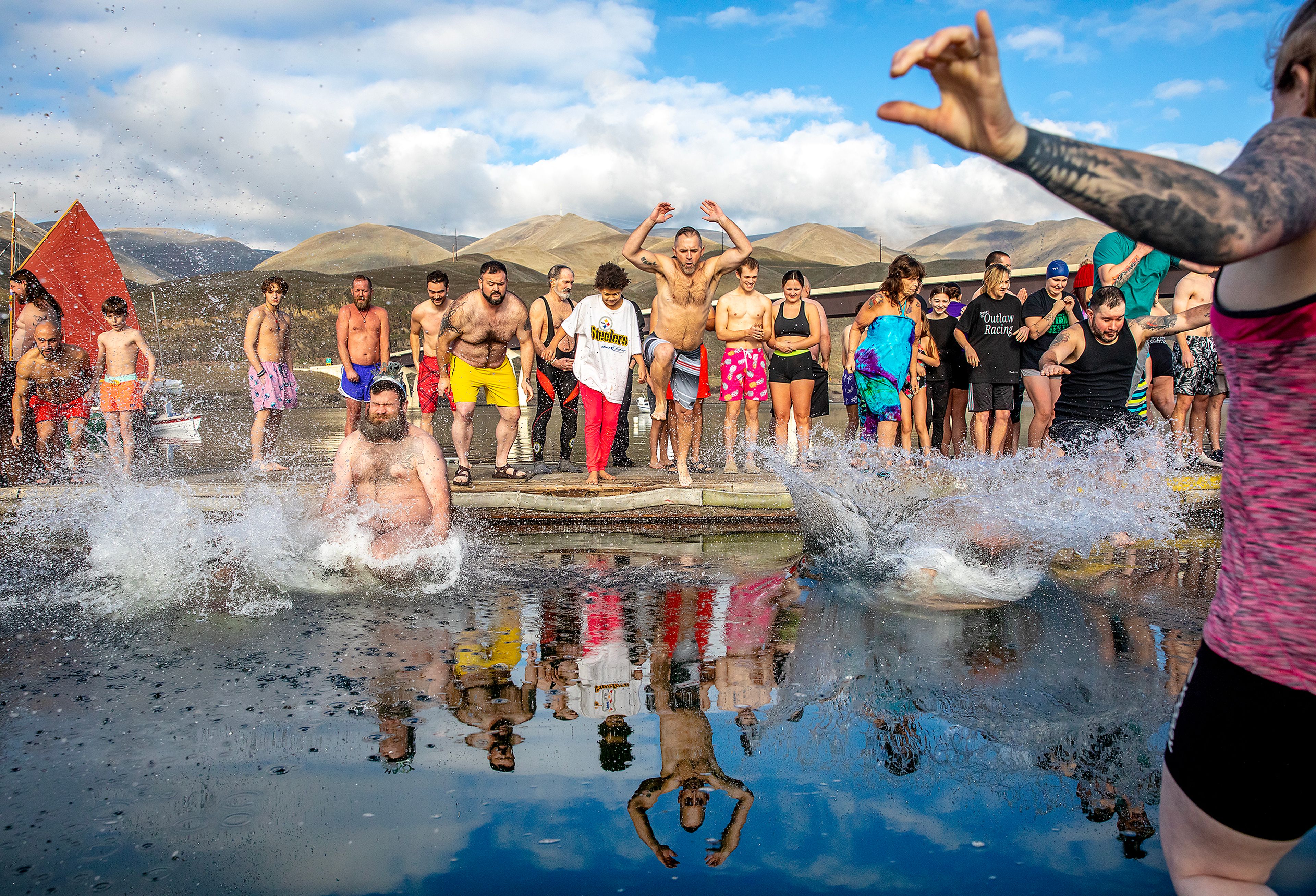 People take the first jump into the Snake River for the annual Polar Plunge Monday in Clarkston.