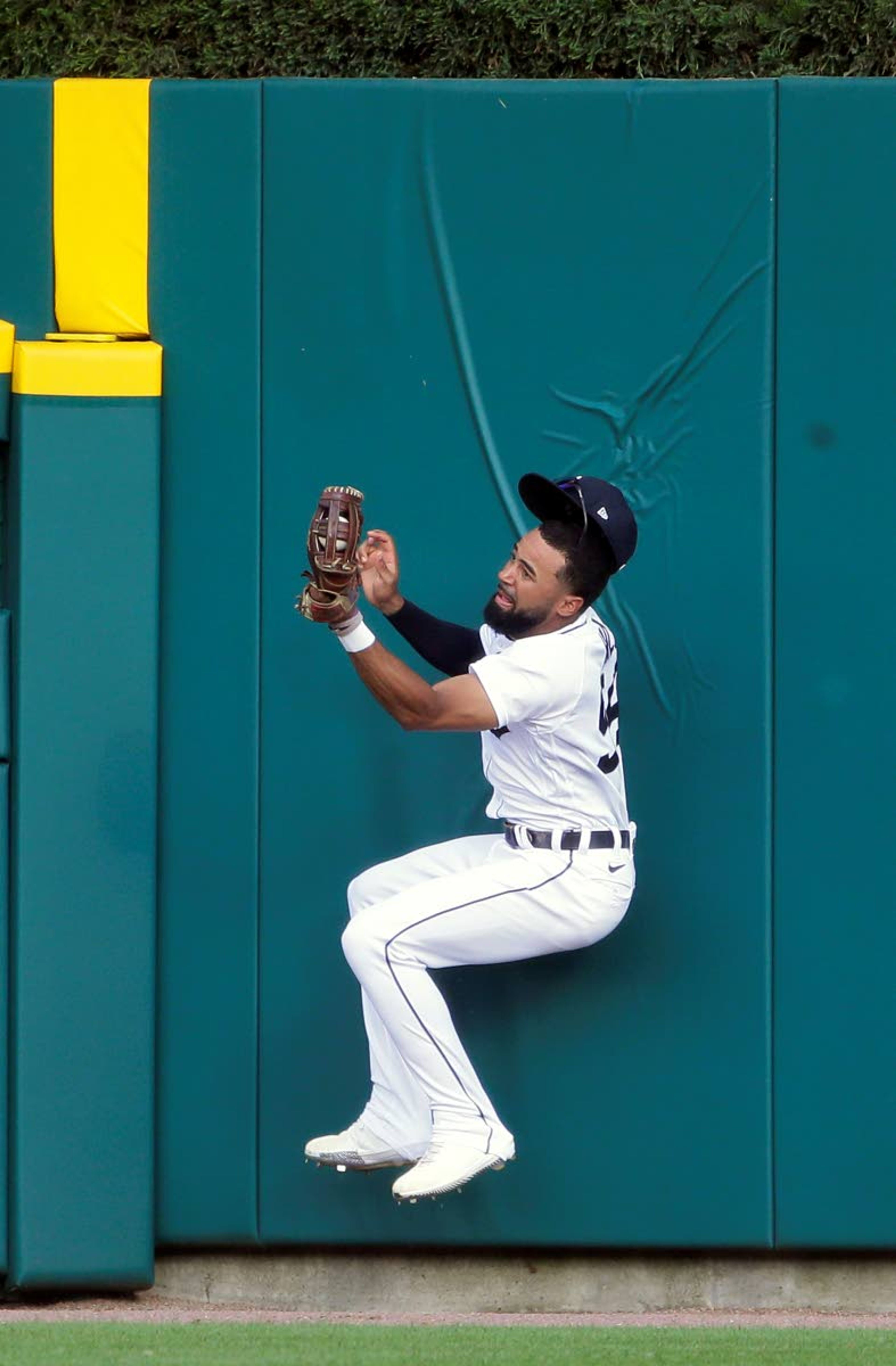 Detroit Tigers center fielder Derek Hill falls back to the ground after making a leaping catch of a fly ball hit by Seattle Mariners' Kyle Seager during the first inning of a baseball game Wednesday, June 9, 2021, in Detroit. Hill left the game with an injury. (AP Photo/Duane Burleson)