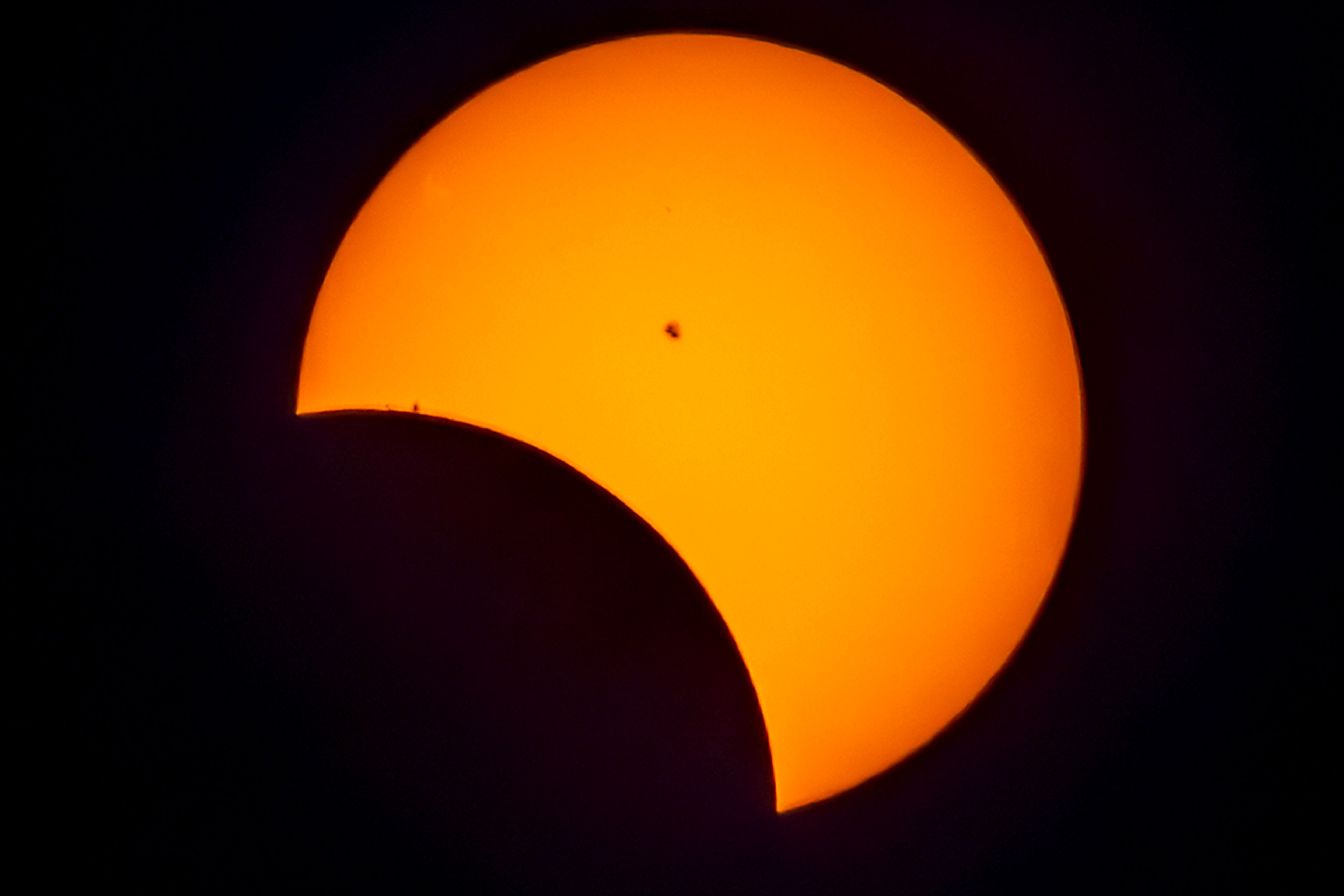 A partial solar eclipse is seen Monday, April 8, 2024, in Lewiston. In the valley the moon covered 29.20 percent of the sun. Capturing the solar eclipse required the use of a filter over the camera lens. The filter is made out of the same material as solar eclipse glasses and darkens everything but the sun, allowing for a picture showing the orange of the sun, the moon covering it, and even sun spots.