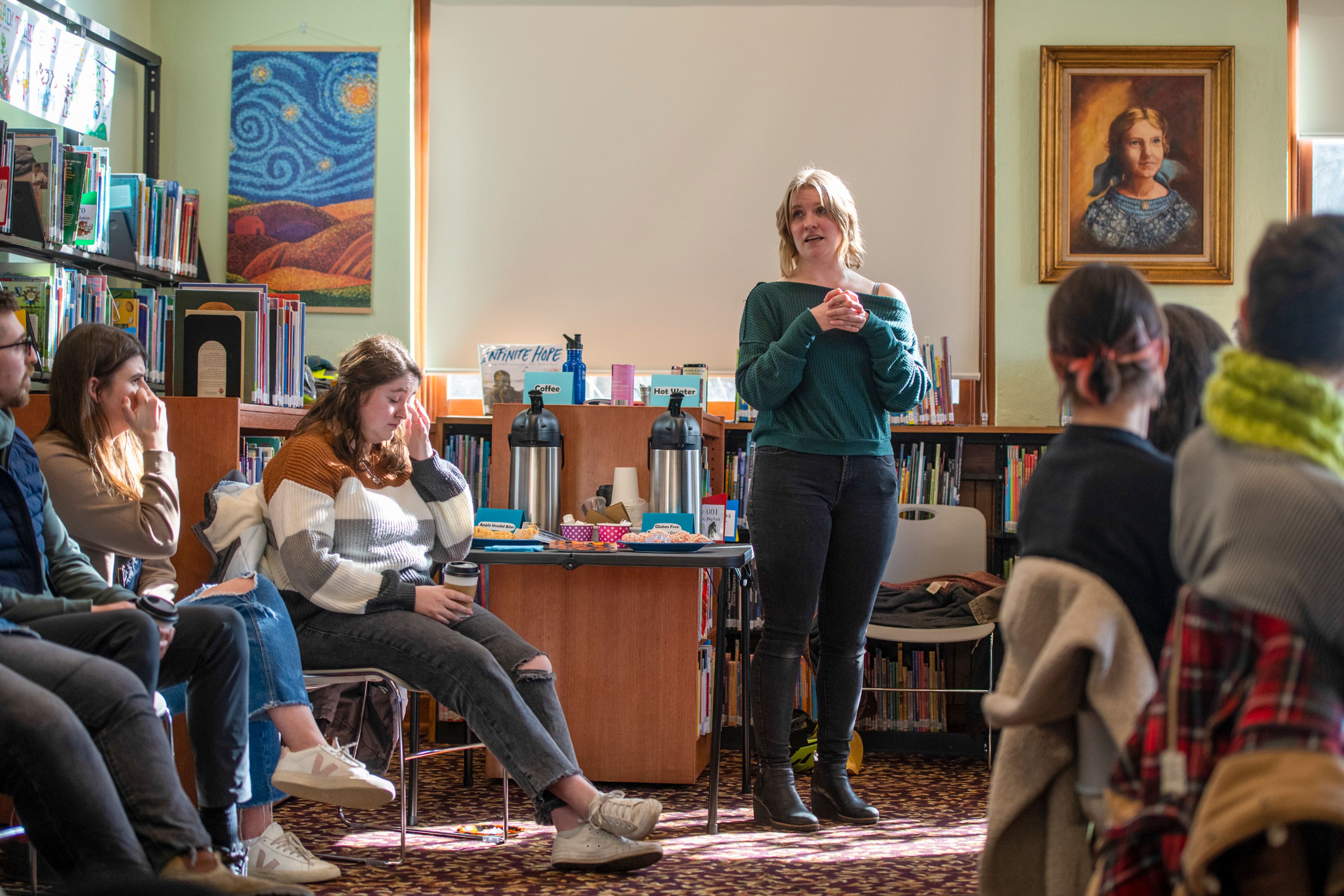 Amber Ziegler, standing, leads introductions during a Death Café, an informal discussion about death, Tuesday at the Moscow Public Library.