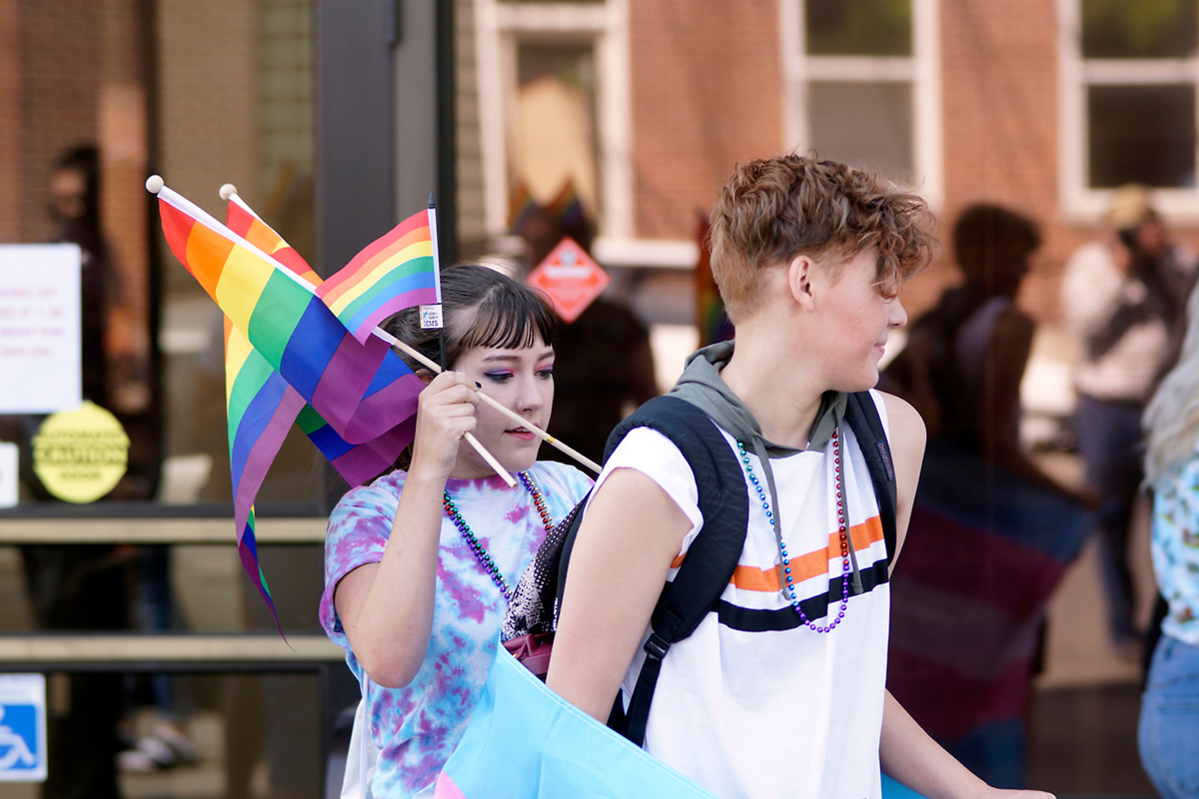 Emma Balderson, left, puts a rainbow flag in Murphy Tverdy's backpack before the start of Moscow's pride march in August.