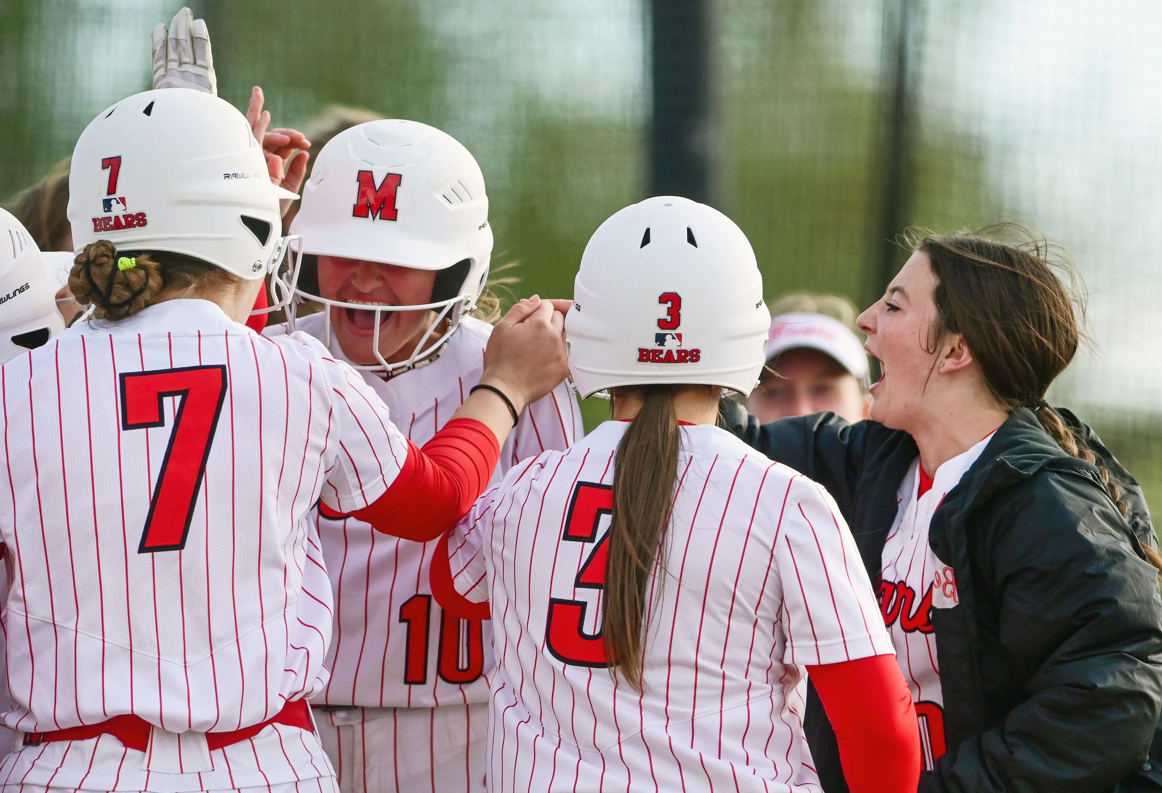 Moscow players gather around teammate Kaci Kiblen (10), center, to celebrate Kiblen’s home run during a game against Lakeland in Moscow on May 7.