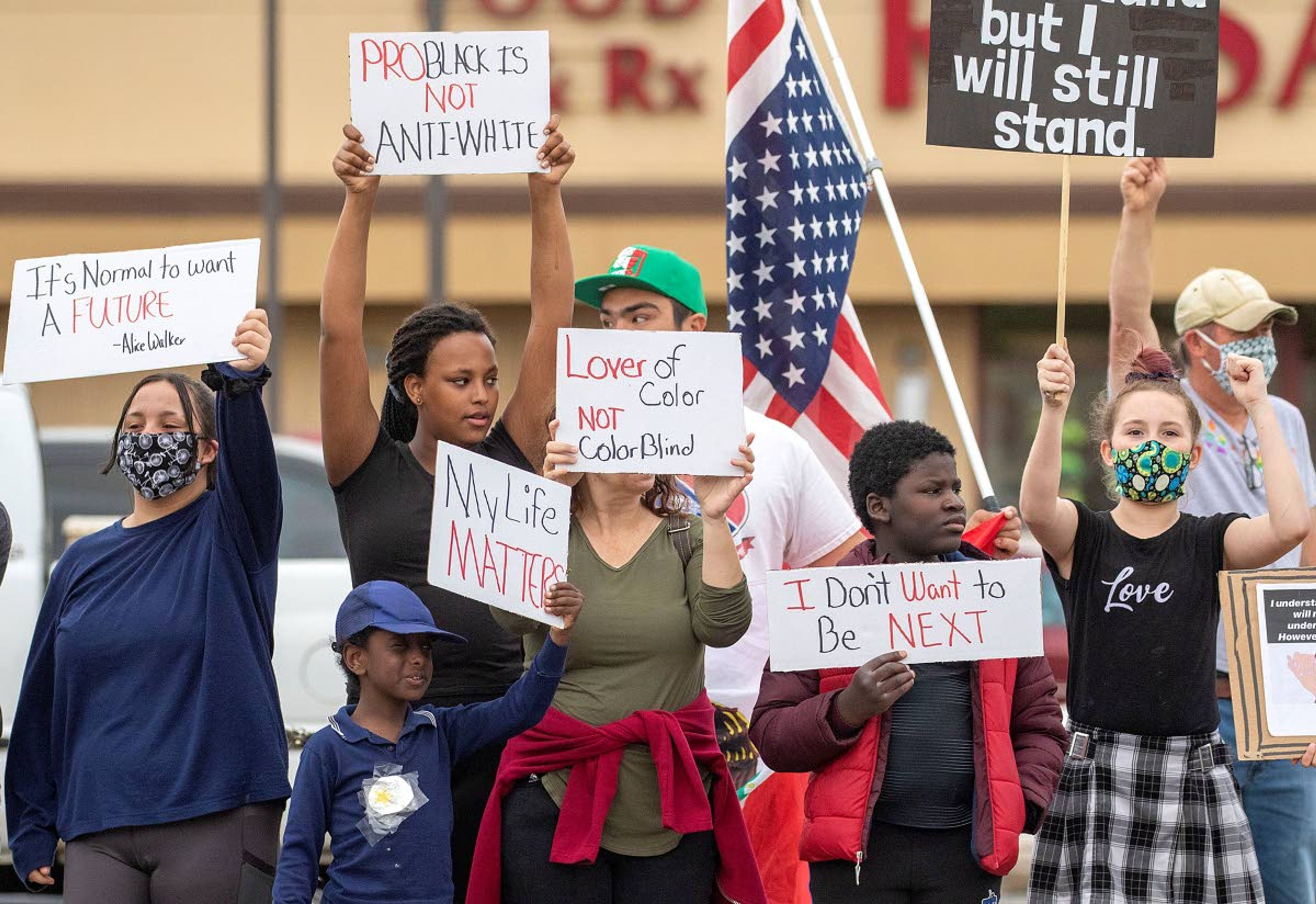 ABOVE AND BELOW: Protesters hold signs and chant during a demonstration over the death of George Floyd on Friday at the intersection of D and Main streets in Moscow. More than 50 people participated in the demonstration.