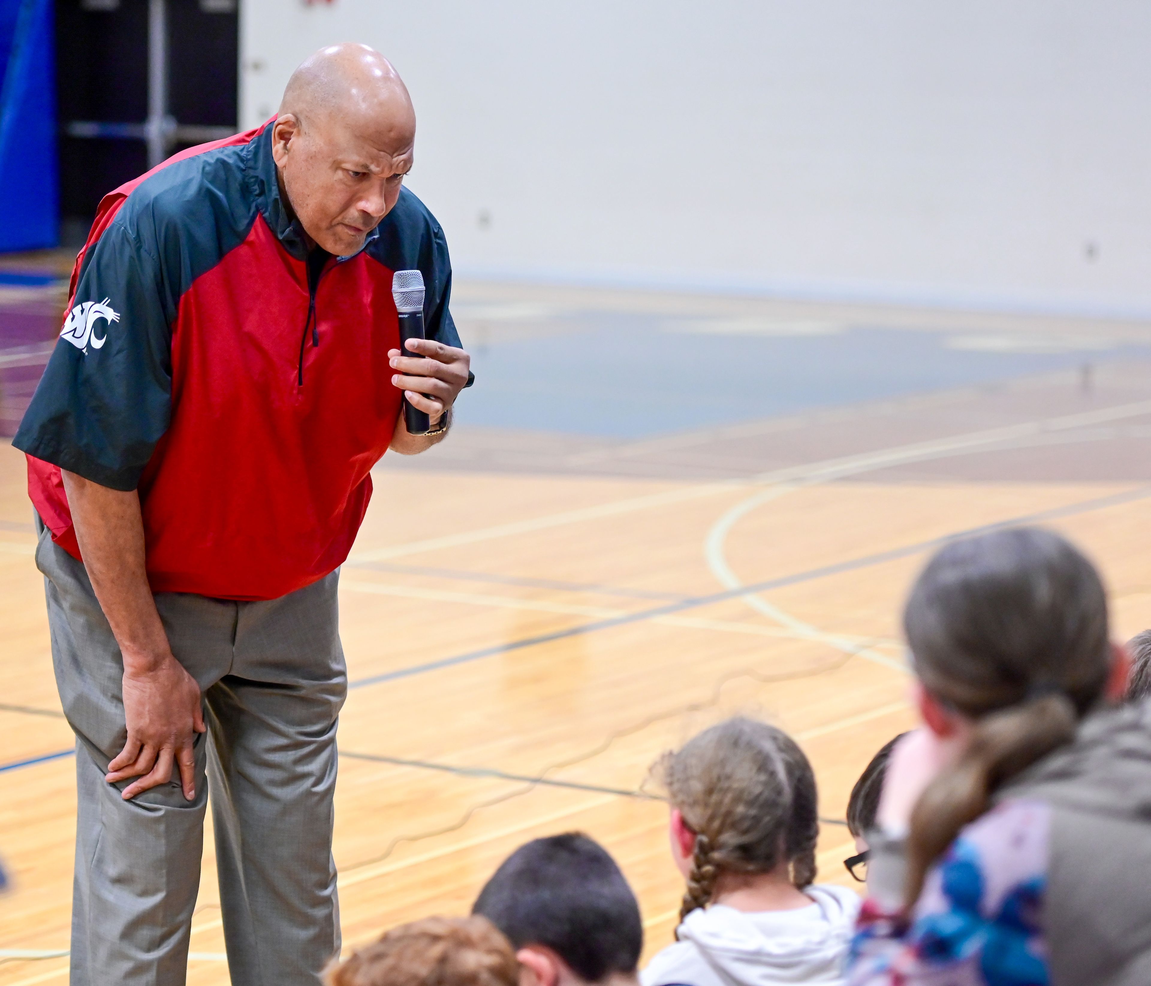 Former NBA and WSU athlete James Donaldson bends down to hear a Colton High School student’s remark as he speaks about mental health to students on Tuesday.