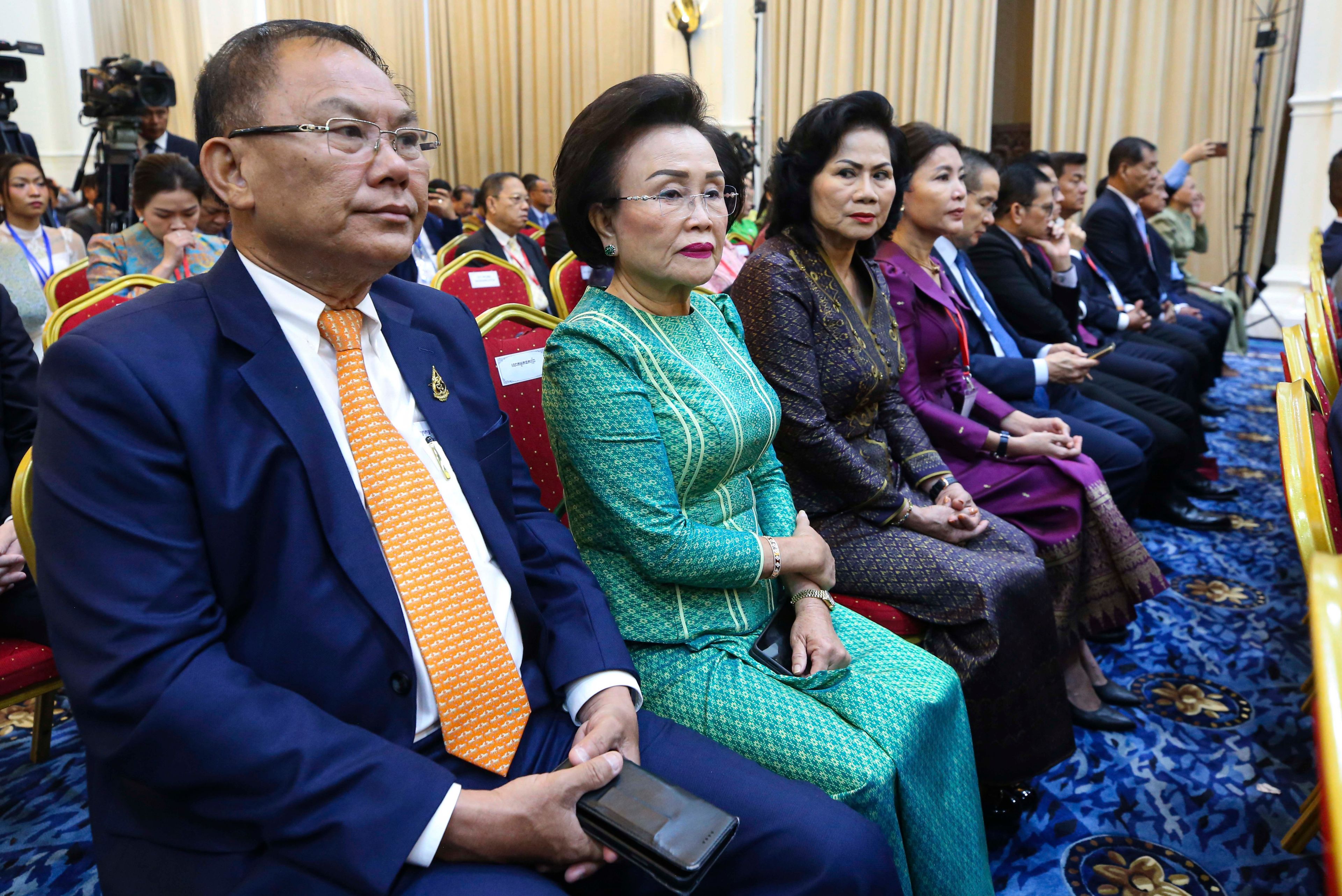 In this photo released by Agence Kampuchea Press (AKP), Cambodian businesspeople, Ly Yong Phat, the president of the L.Y.P. Group, left, and Choeung Sopheap, second from left, attend a ceremony for the return of artifacts at Peace Palace in Phnom Penh, Cambodia, Thursday, Aug. 22, 2024. (AKP via AP)