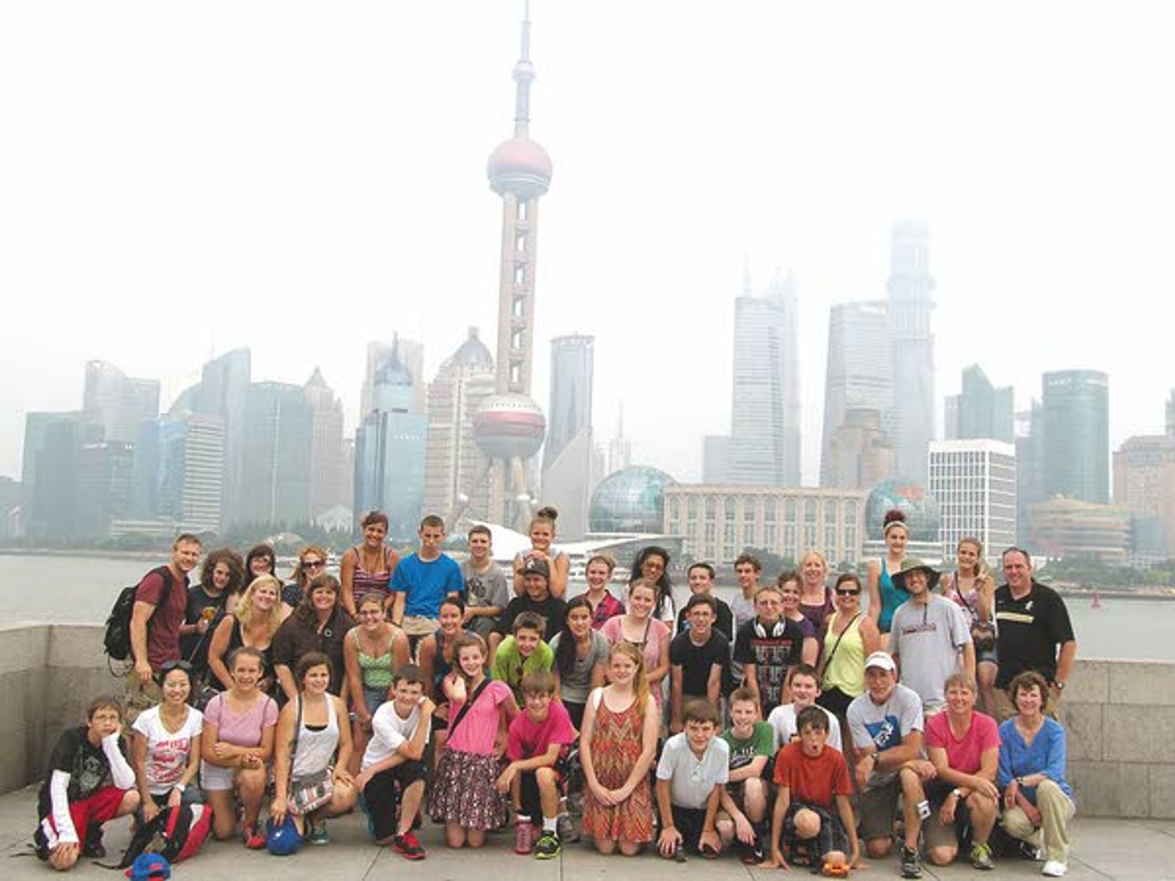 Moscow Middle and High School students, teachers and chaperones stand in front of the Shanghai skyline in a photo taken earlier this month.