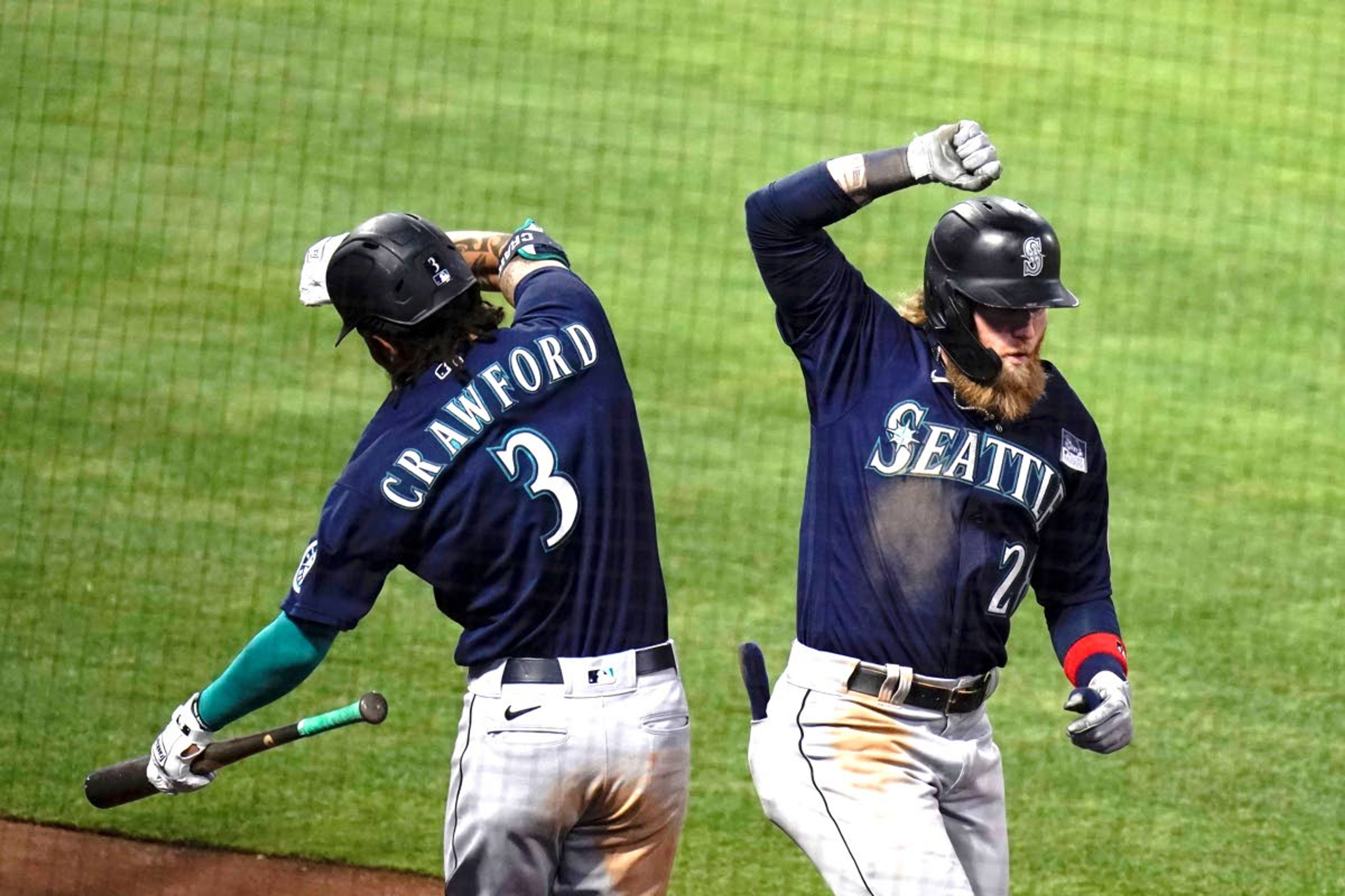 Seattle Mariners' Jake Fraley, right, celebrates his three-run home run with J.P. Crawford during the fourth inning of the team's baseball game against the Los Angeles Angels in Anaheim, Calif., Thursday, June 3, 2021. (AP Photo/Jae C. Hong)