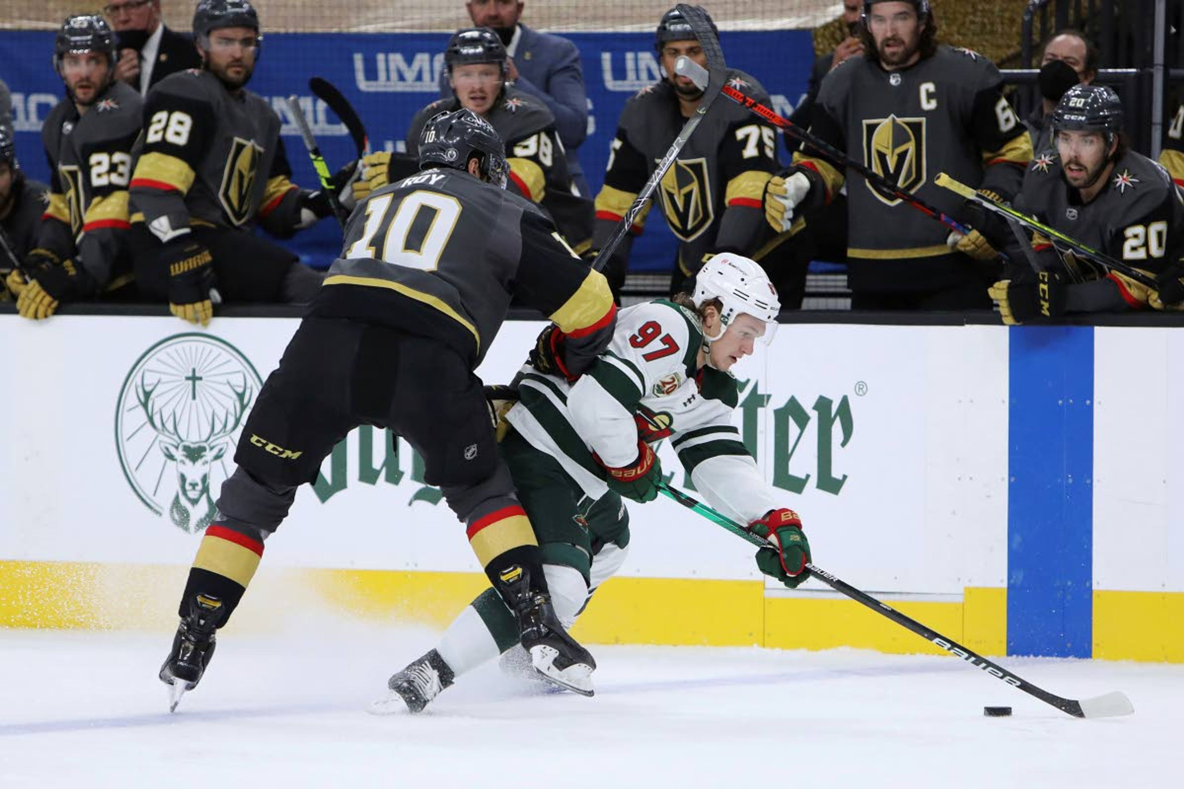 Minnesota Wild left wing Kirill Kaprizov (97) vies for the puck against Vegas Golden Knights center Nicolas Roy (10) during the second period of Game 7 of an NHL hockey Stanley Cup first-round playoff series Friday, May 28, 2021, in Las Vegas. (AP Photo/Joe Buglewicz)