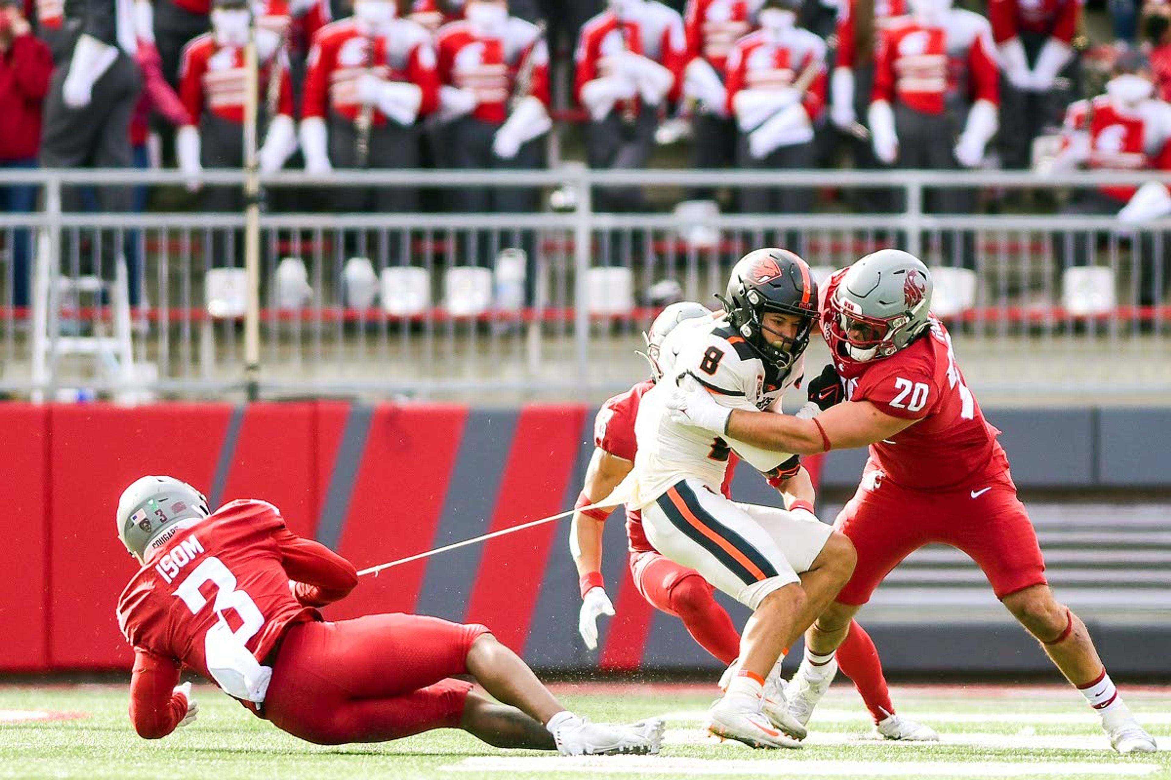 Washington State defensive back Daniel Isom (3) pulls on the jersey of Oregon State wide receiver Trevon Bradford (8) as teammate defensive end Quinn Roff (20) tackles Bradford after he made a catch in the third quarter of a Pac-12 game on Saturday afternoon at Martin Stadium in Pullman.