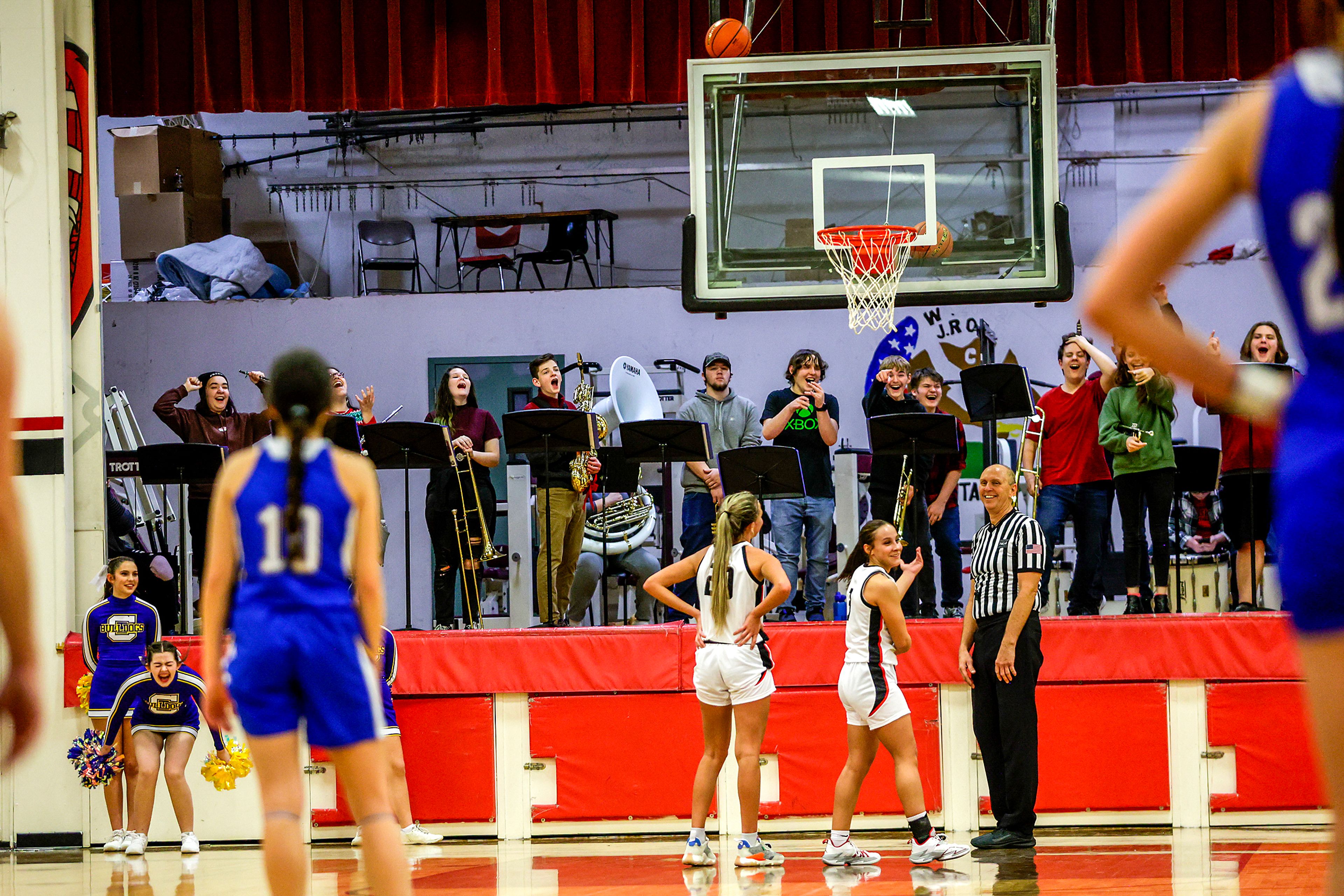 People react as the ball being used to unstick a ball on the top of the backboard gets stuck itself in a quarter of a nonleague game Thursday at Clarkston.