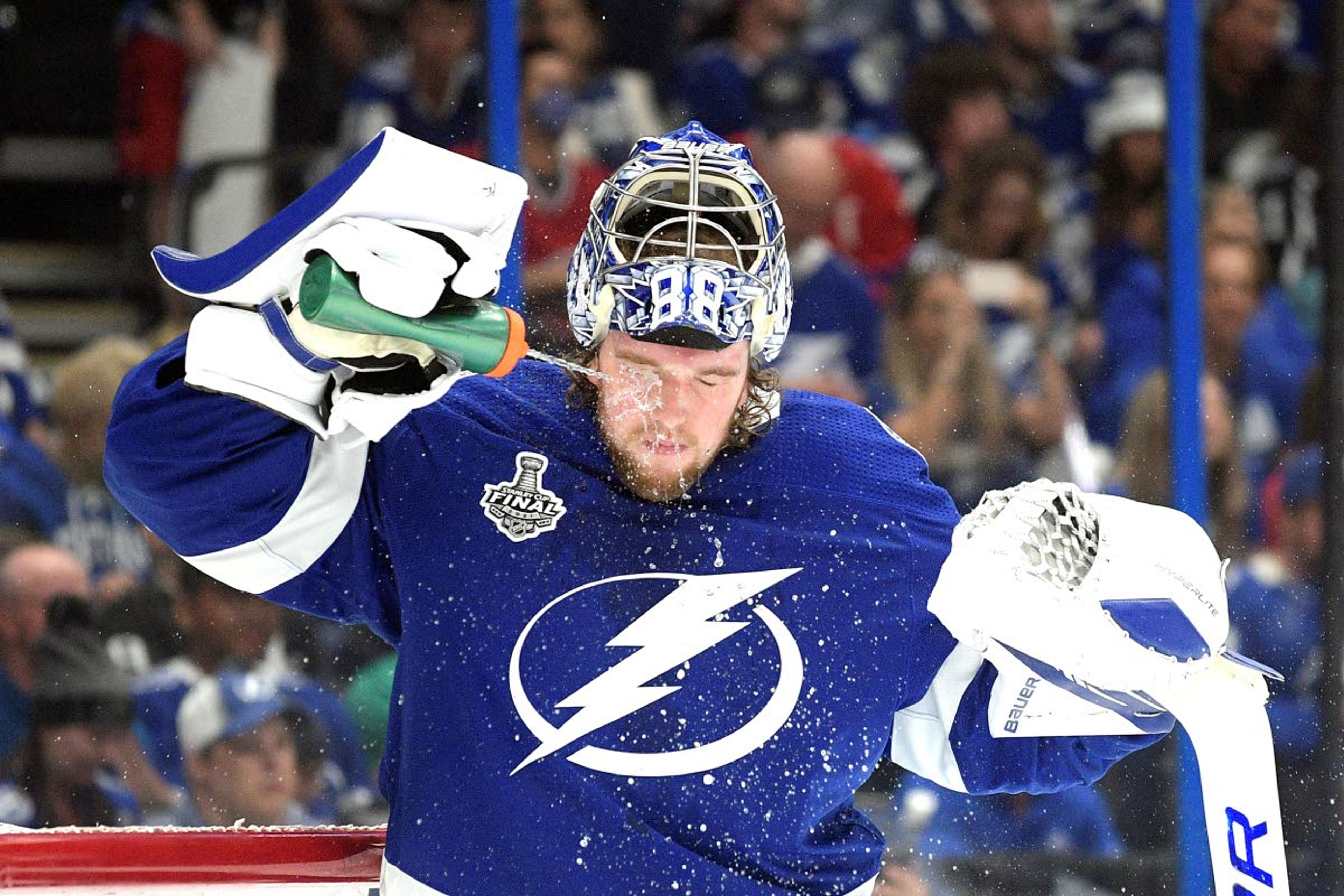 Tampa Bay Lightning goaltender Andrei Vasilevskiy squirts his face during the first period in Game 1 of the NHL hockey Stanley Cup finals against the Montreal Canadiens, Monday, June 28, 2021, in Tampa, Fla. (AP Photo/Phelan Ebenhack)