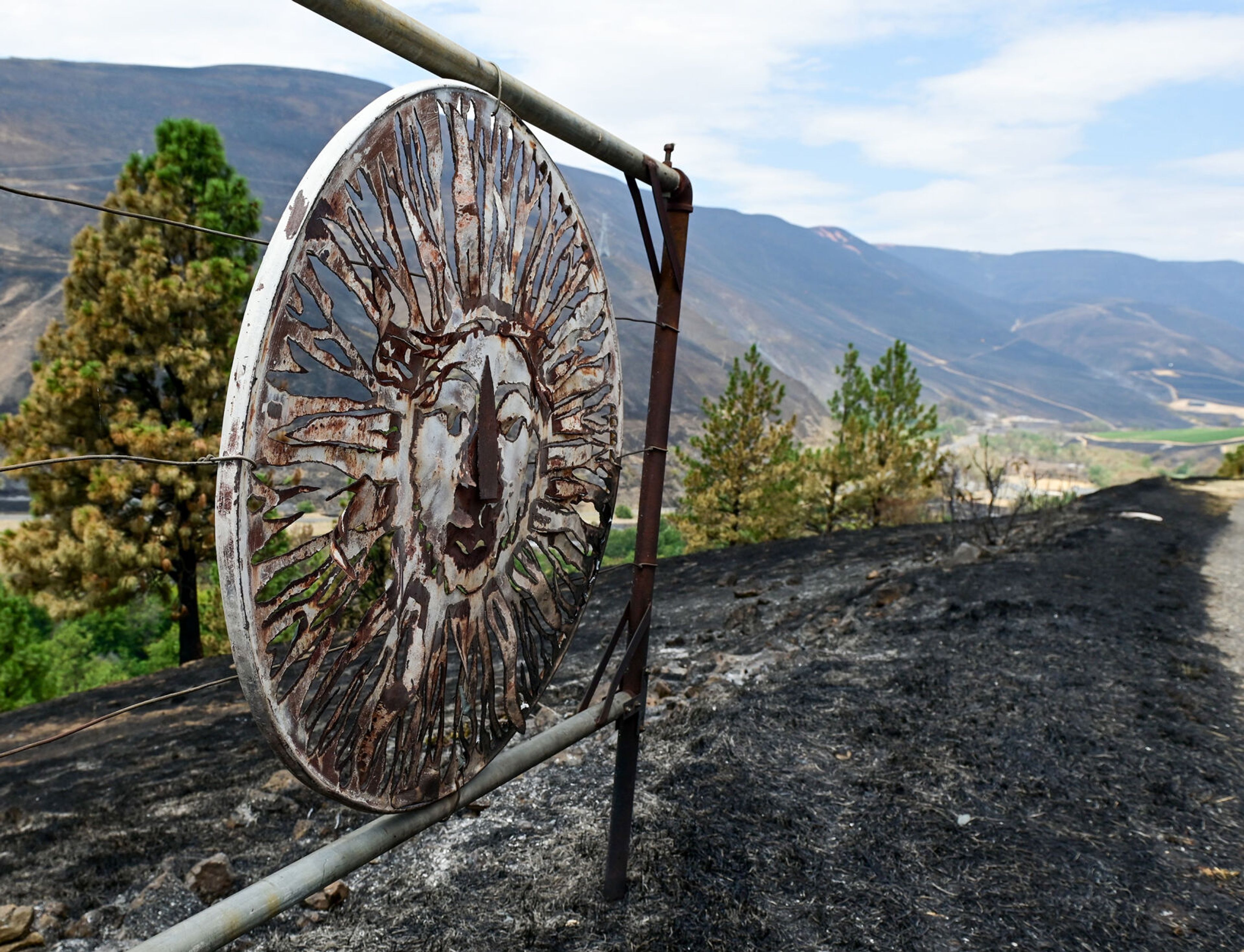 The entry gate to the Colter’s Creek Winery shows signs of damage on Monday after the Juliaetta winery was engulfed in the Gwen Fire.