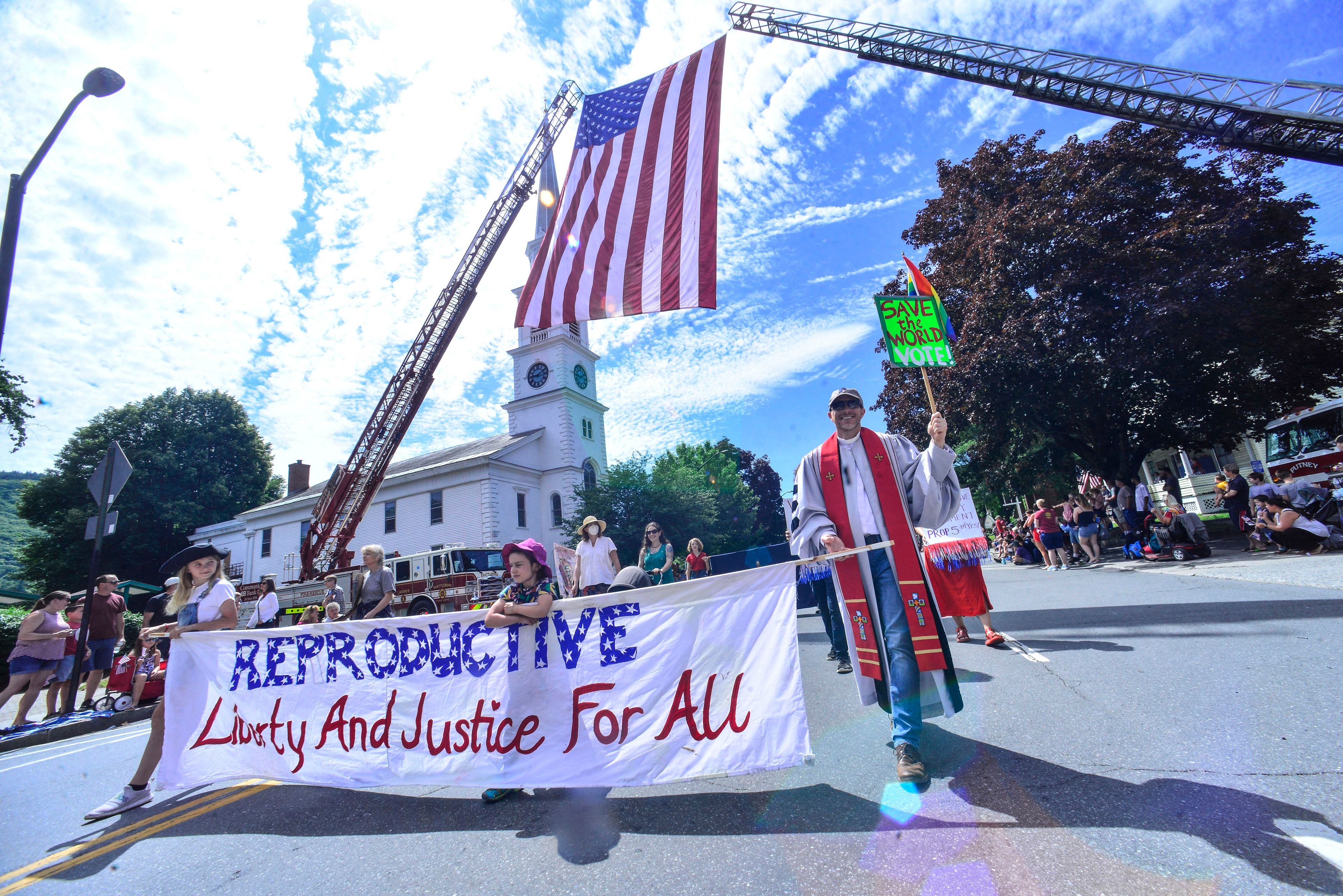 Various activities and protesters for different causes march down Main Street, in Brattleboro, Vt., during the Fourth of July parade on Monday, July 4, 2022. (Kristopher Radder/The Brattleboro Reformer via AP)