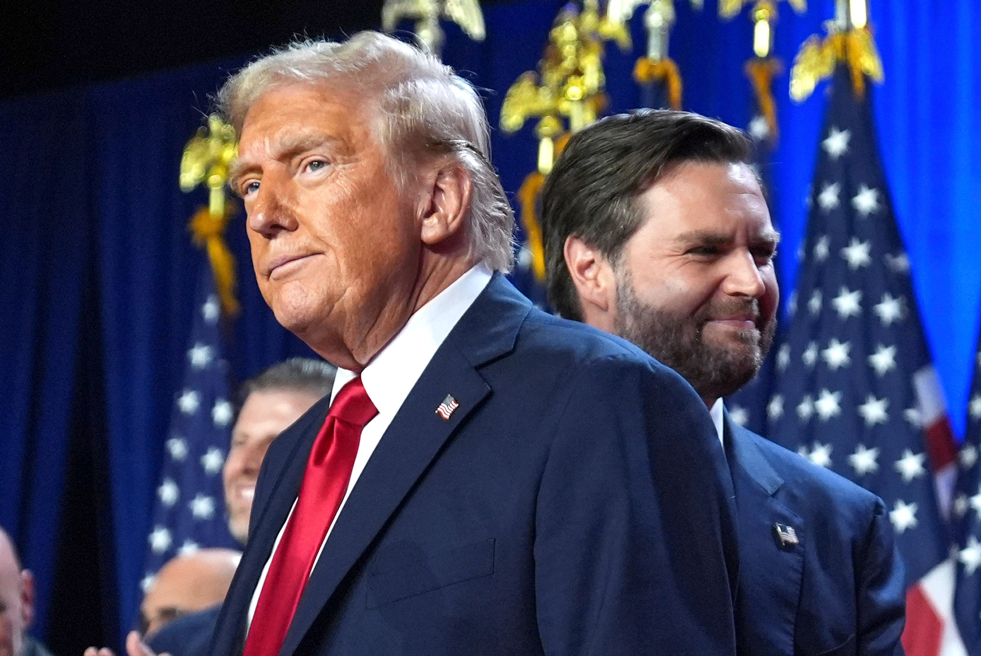 Republican presidential nominee former President Donald Trump and his running mate Sen. JD Vance, R-Ohio, stand on stage at an election night watch party at the Palm Beach Convention Center, Wednesday, Nov. 6, 2024, in West Palm Beach, Fla. (AP Photo/Evan Vucci)