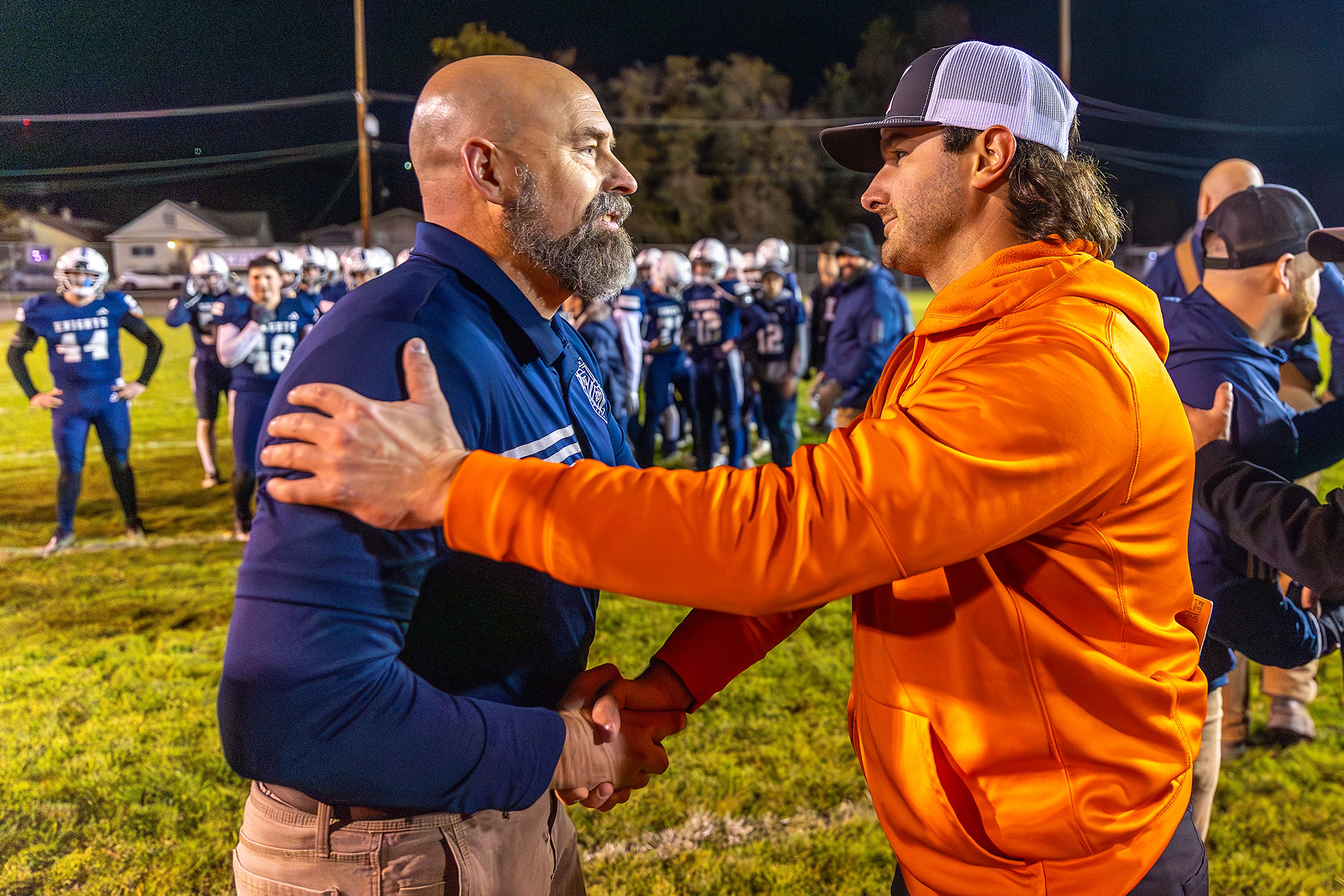 Kendrick head coach Zane Hobart shakes hands with Logos head coach Nick Holloway in a semifinal game of the Idaho State Football Class 2A Championships Friday at Bengal Field in Lewiston.