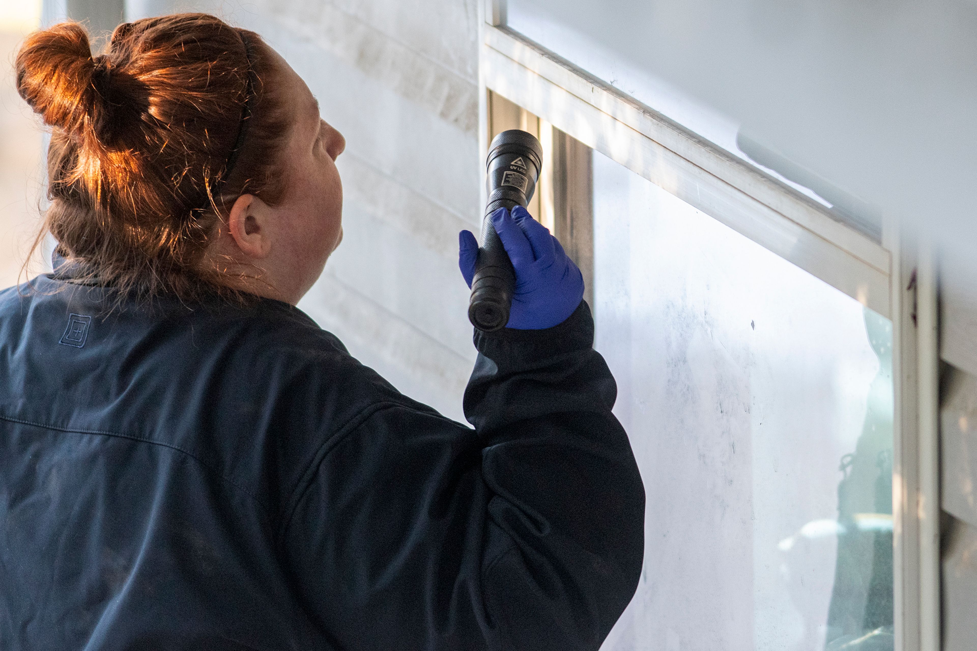 A member of the Idaho State Police forensic team investigates Friday at a home where four University of Idaho students were recently murdered over the weekend in Moscow.