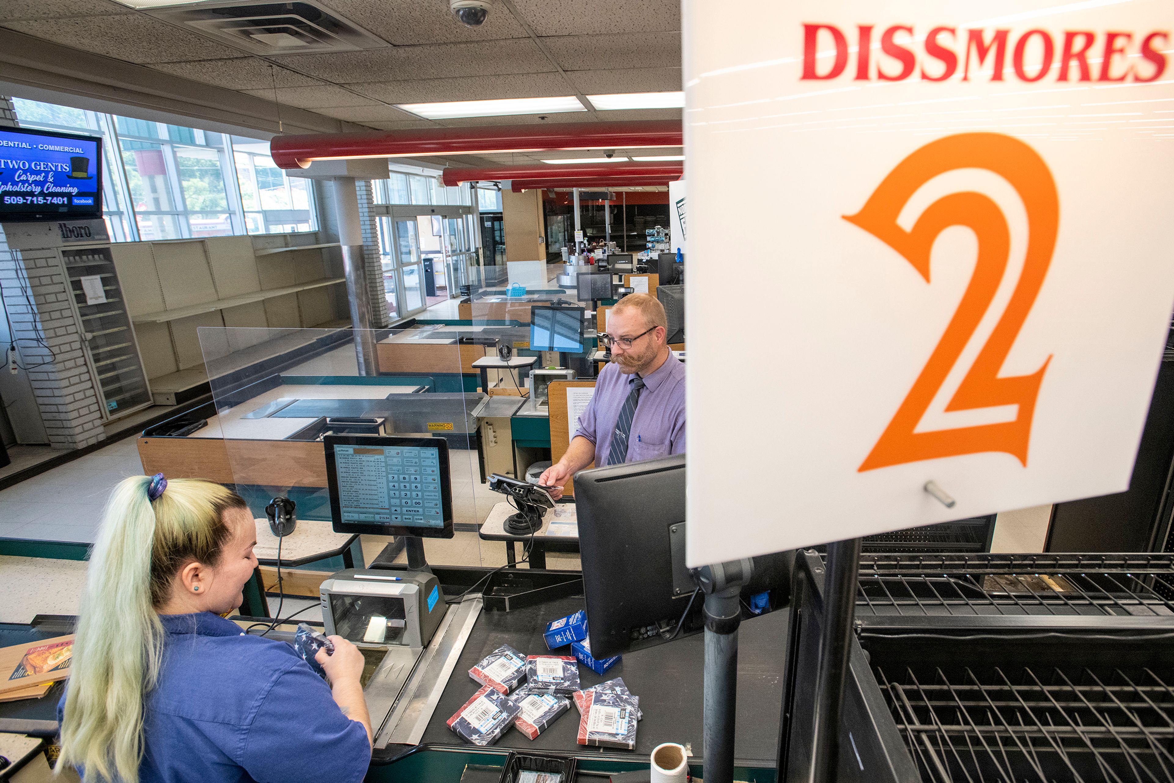 Zach Wilkinson/Daily NewsCashier Taylor Sorrell completes a transaction Friday with Jesse Cheney at Dissmore’s IGA on its final day of business in Pullman. “I first came here 23 years ago. It’s been a great place to stop by, always nice and helpful people to help me out,” Cheney said. Sorrell added, “I’ve made some really good connections with my co-workers and customers. It’s going to be sad to see them go, but I’ll see them around town.”