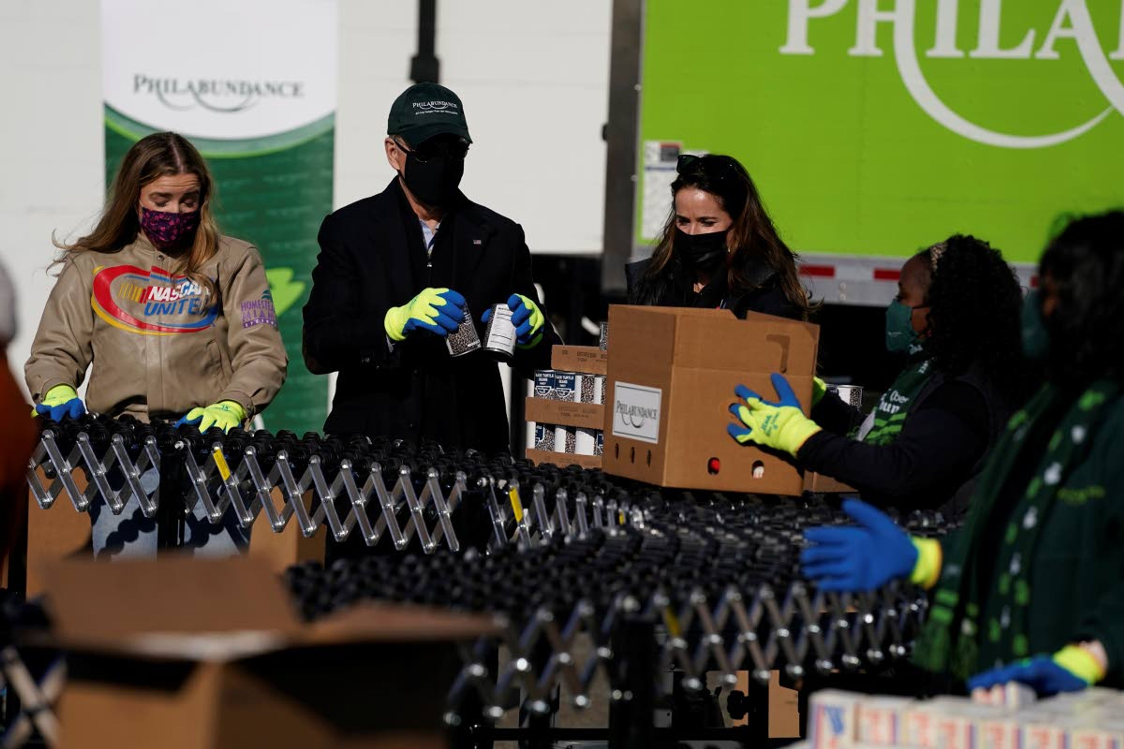 President-elect Joe Biden participates in a National Day of Service event at Philabundance, a hunger relief organization, with his daughter Ashley Biden, and his granddaughter Finnegan Biden, left, Monday, Jan. 18, 2021, in Philadelphia. (AP Photo/Evan Vucci)