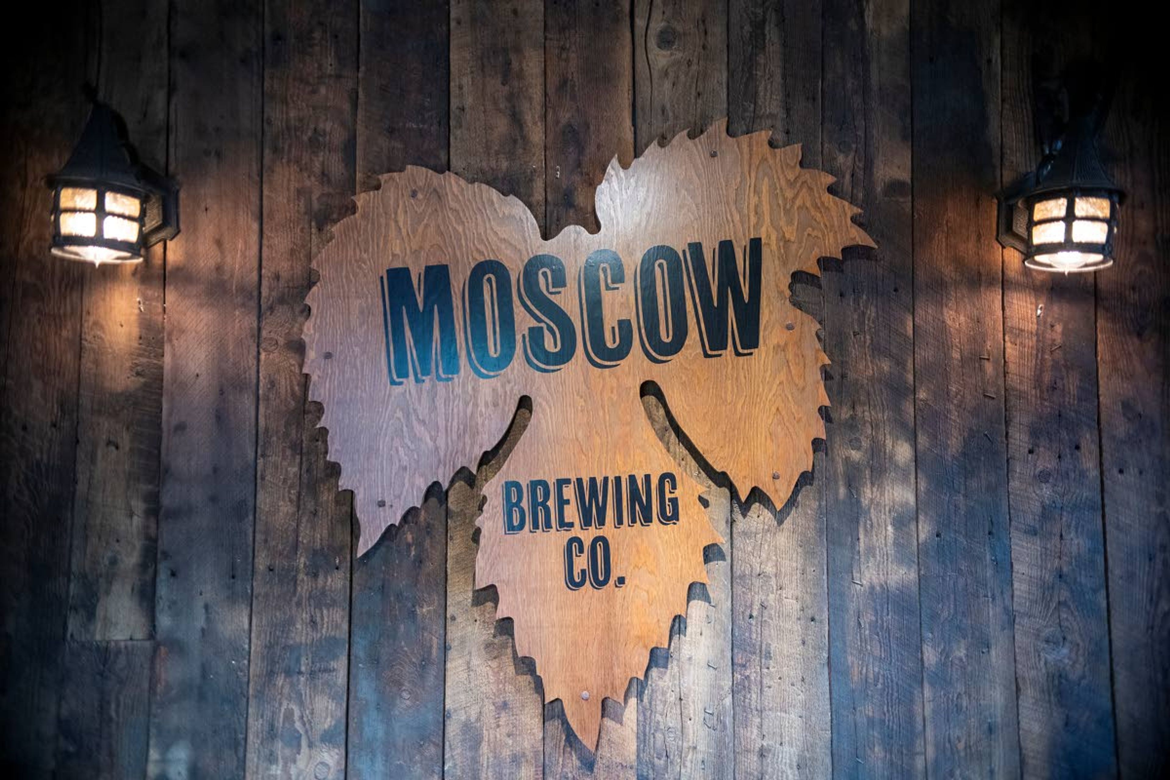 A sign is displayed on the wall at the entrance of Moscow Brewing Company.