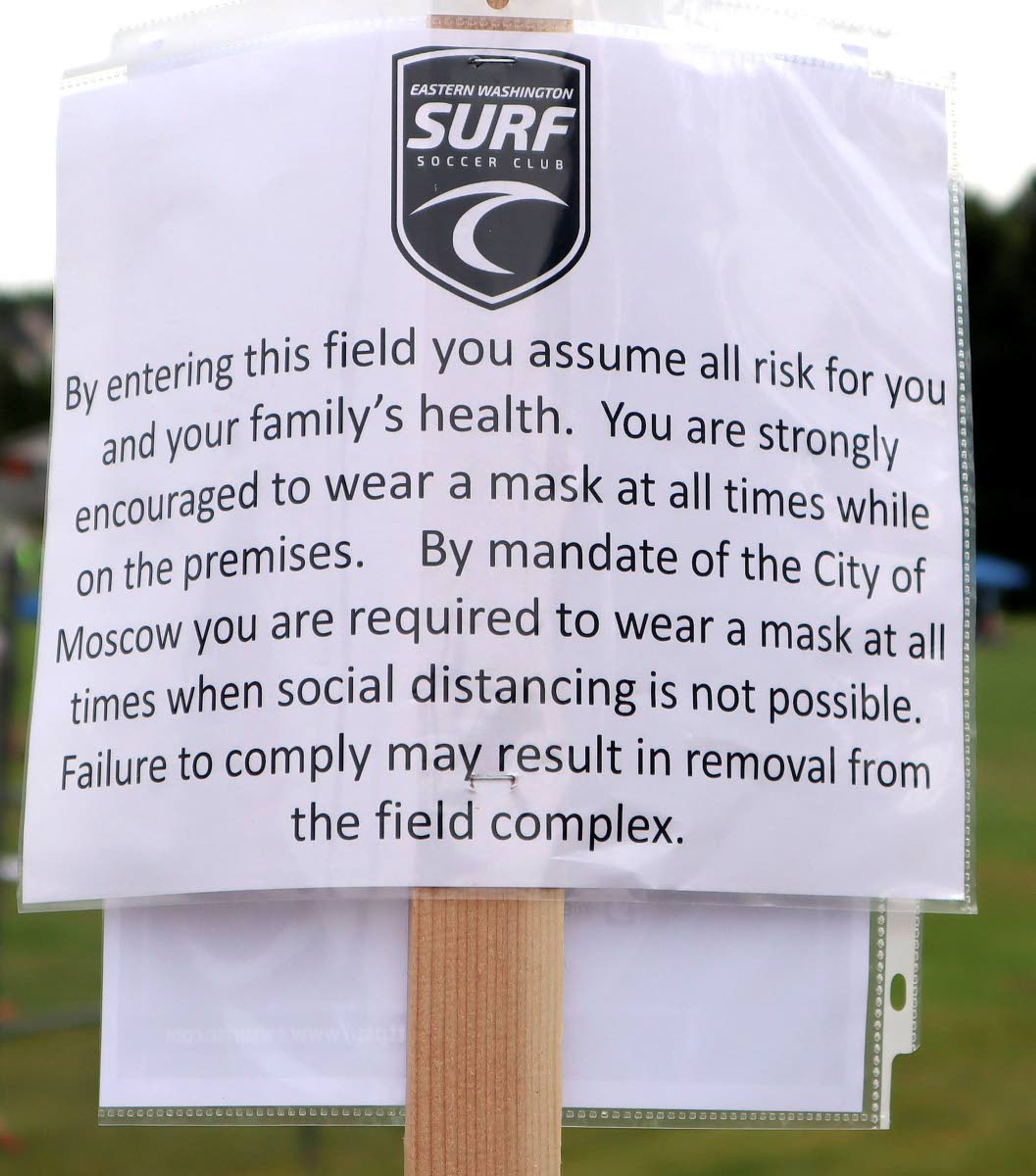 A sign encourages participants to wear facial coverings during the Eastern Washington Surf Soccer Club Harvest Cup soccer tournament. The tournament was shut down on Sunday for violating the Moscow Mayor's order to wear masks in public places when social distancing isn't possible.