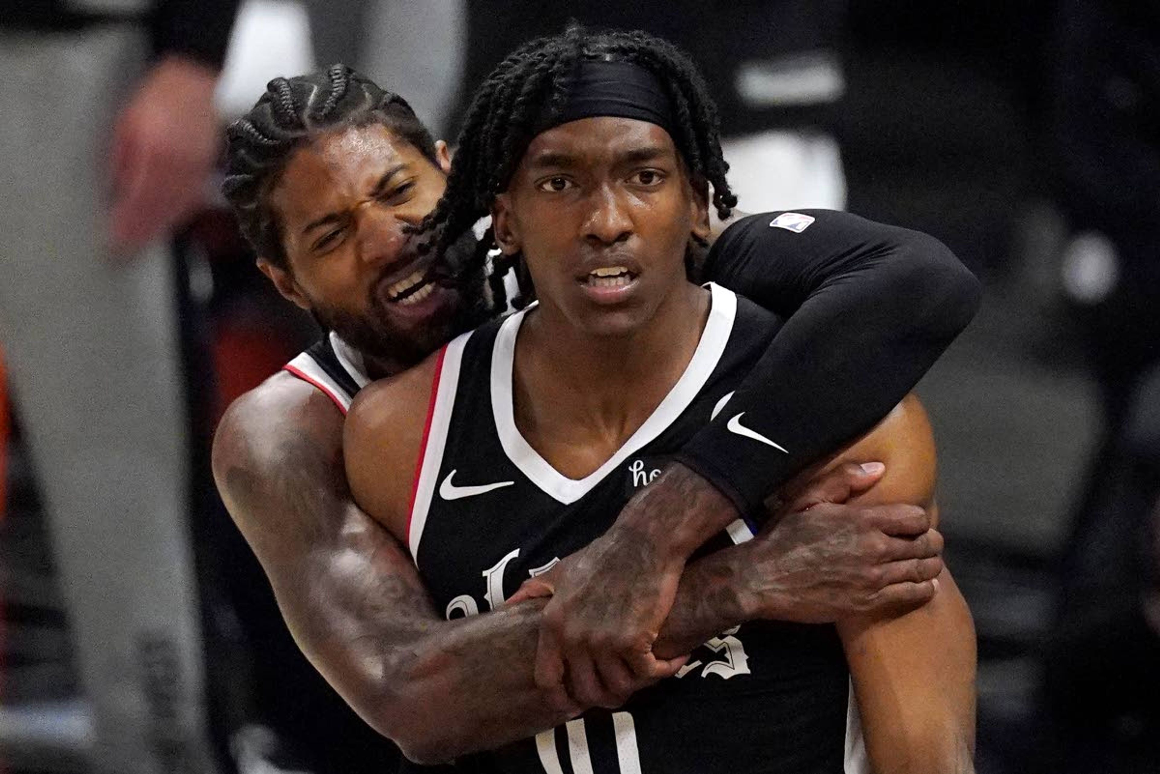 Los Angeles Clippers guard Terance Mann, right, celebrates with guard Paul George after scoring and drawing a foul during the first half in Game 6 of a second-round NBA basketball playoff series against the Utah Jazz Friday, June 18, 2021, in Los Angeles. (AP Photo/Mark J. Terrill)