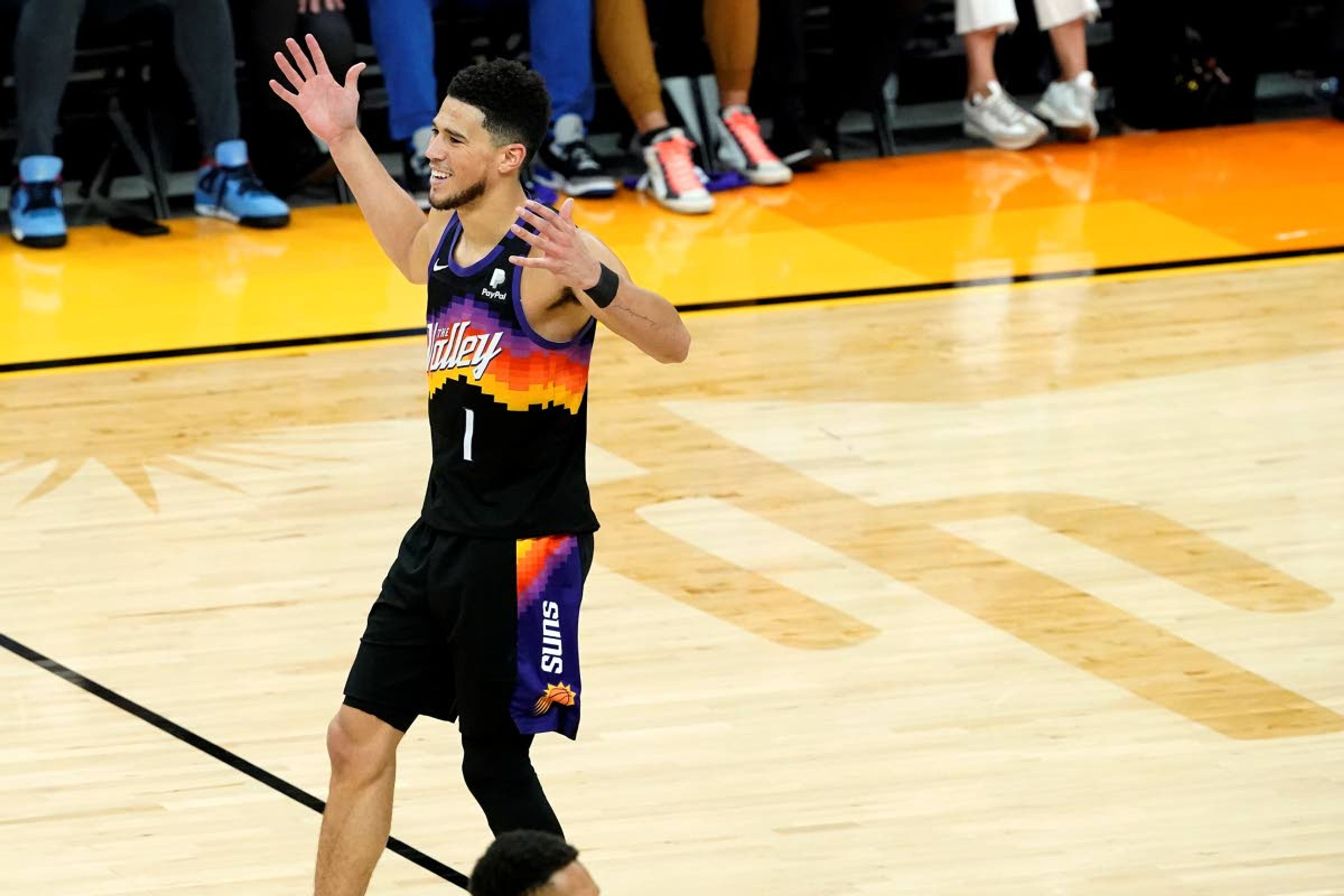 Phoenix Suns guard Devin Booker (1) celebrates during the second half of Game 2 of an NBA basketball second-round playoff series against the Denver Nuggets, Wednesday, June 9, 2021, in Phoenix. (AP Photo/Matt York)