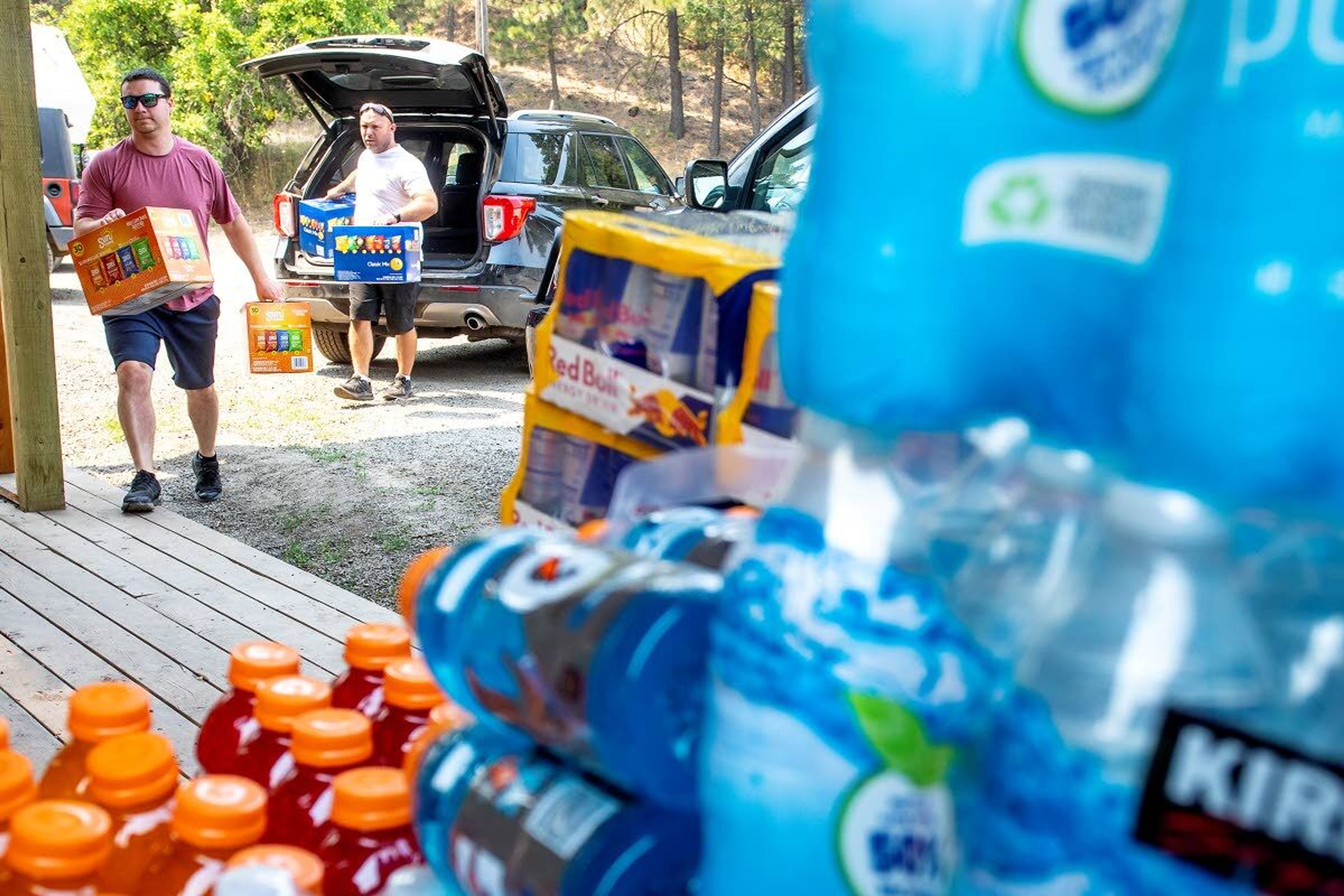 Volunteers unload food and water at the Waha Bar and Grill on Saturday.