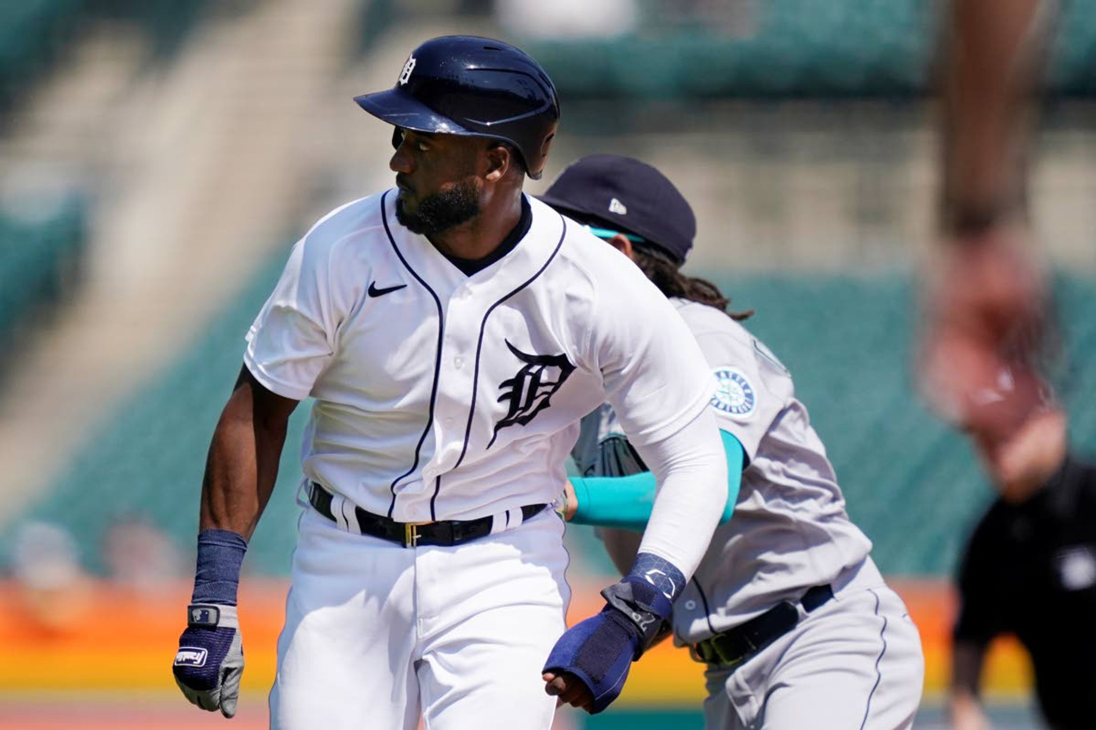 Detroit Tigers' Niko Goodrum is tagged by Seattle Mariners shortstop J.P. Crawford in a rundown between first and second during the seventh inning of a baseball game, Thursday, June 10, 2021, in Detroit. (AP Photo/Carlos Osorio)