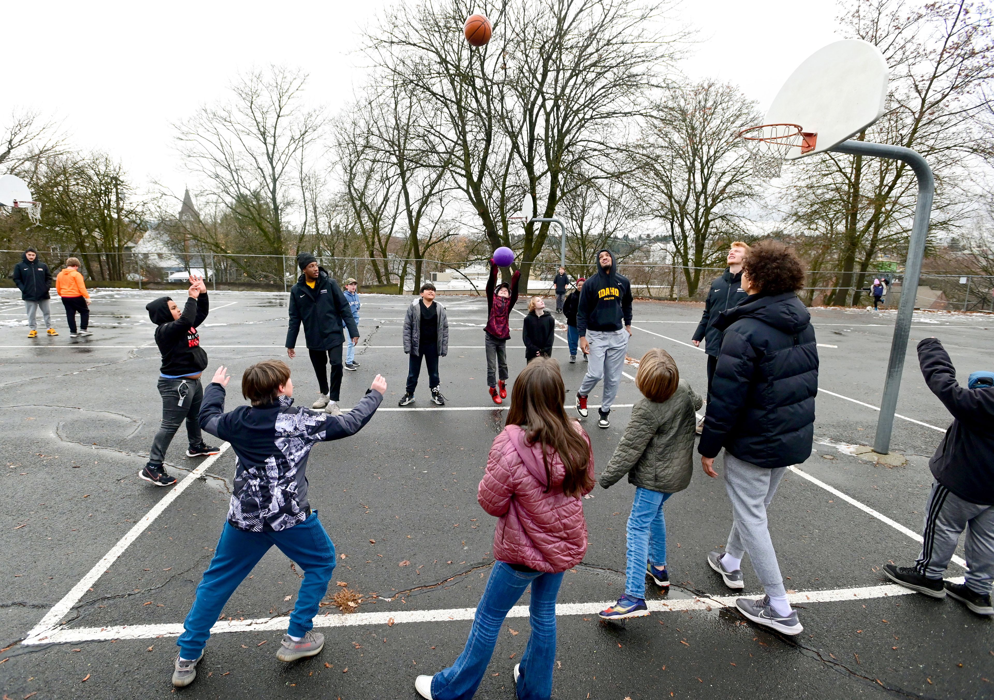 Idaho Vandals line up for a free throw by fifth grader Kalid, left, during recess at John Russell Elementary School in Moscow on Monday. The Vandals visit with students a few times each month during lunch and recess as mentors.