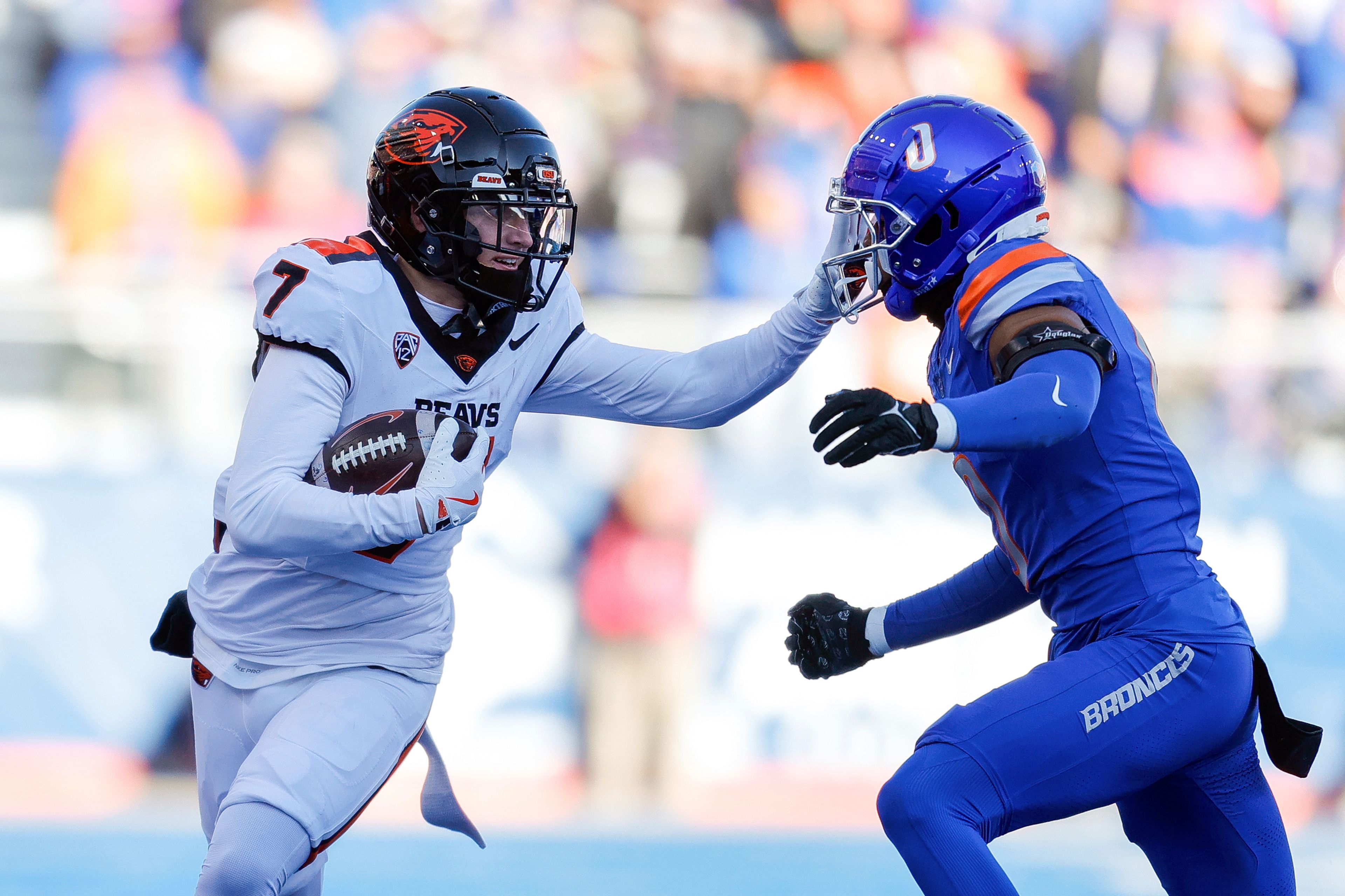 Oregon State wide receiver Trent Walker (7) stiff arms Boise State safety Ty Benefield (0) after a receptions in the first half of an NCAA college football game, Friday, Nov. 29, 2024, in Boise, Idaho. (AP Photo/Steve Conner)