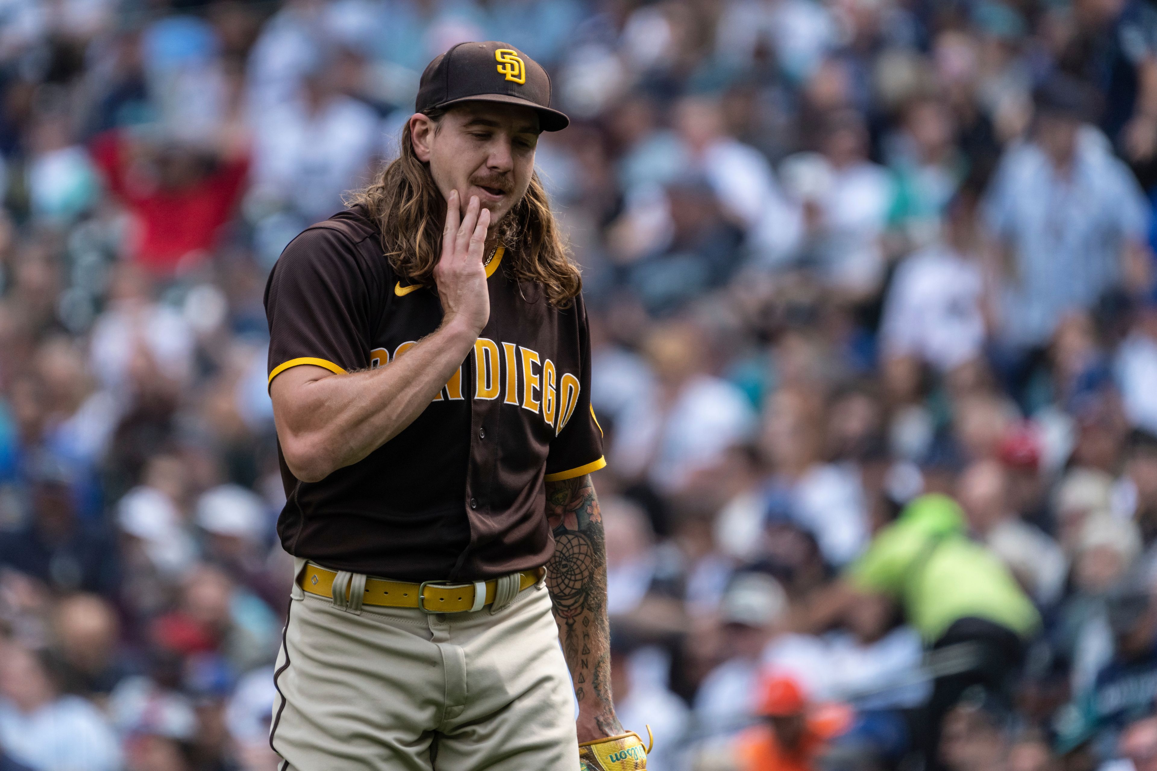 San Diego Padres starting pitcher Mike Clevinger walks off the field after pitching the first inning of a baseball game against the Seattle Mariners, Wednesday, Sept. 14, 2022, in Seattle. (AP Photo/Stephen Brashear)